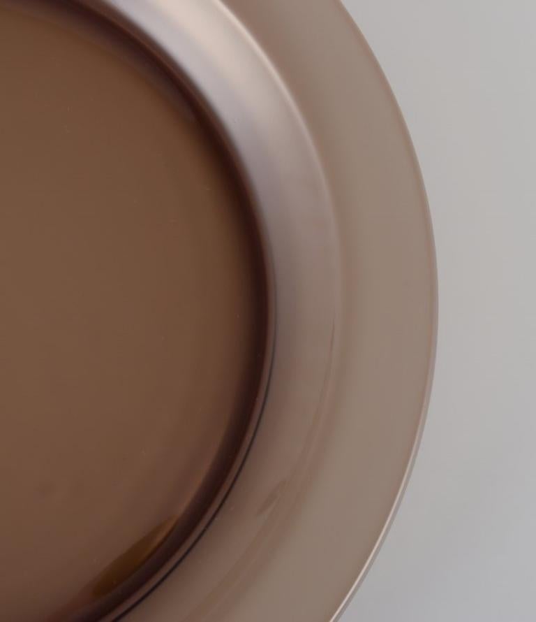 Vereco, France. Set of four dinner plates in smoked art glass. 1970s. In Excellent Condition For Sale In Copenhagen, DK