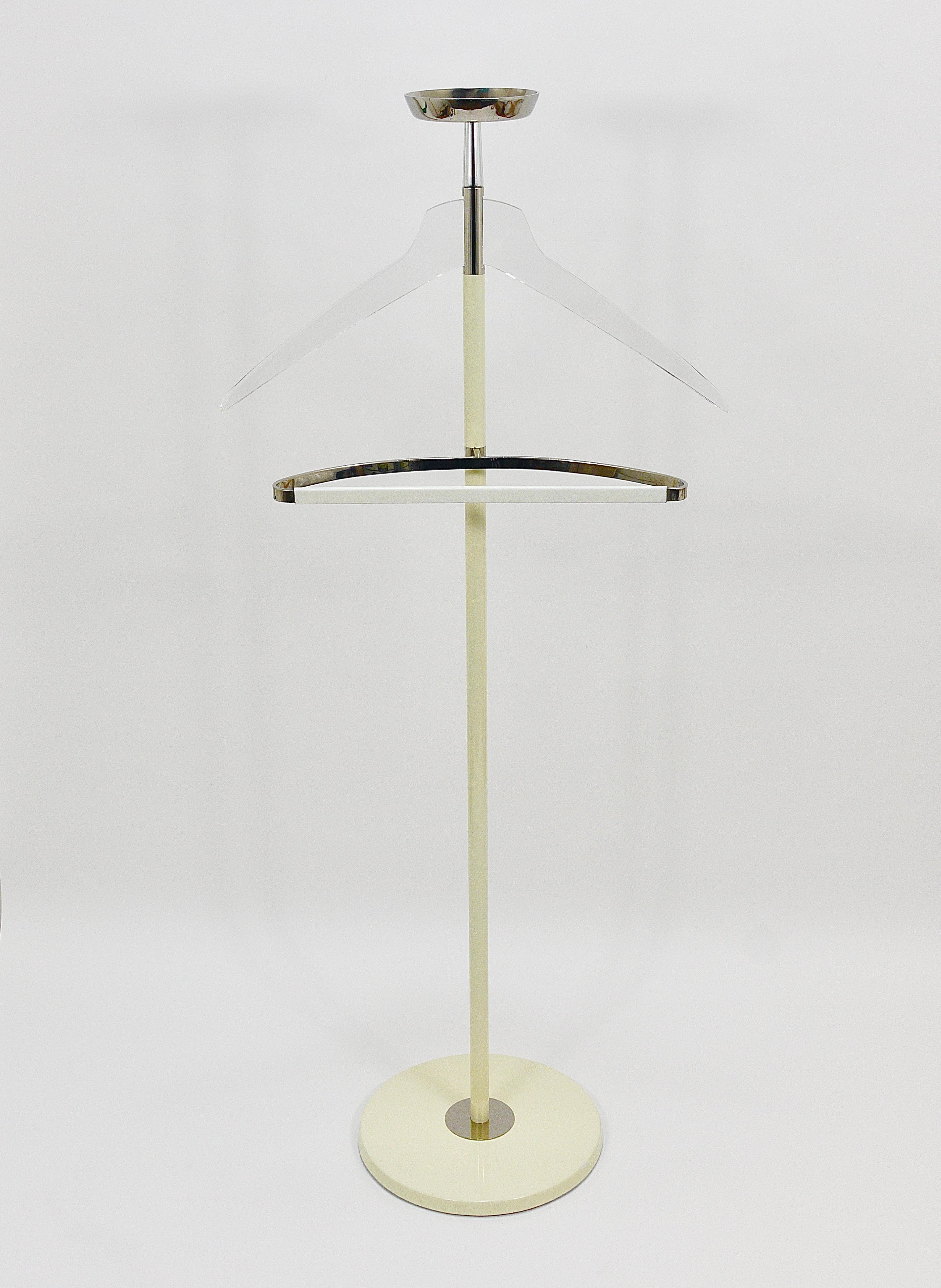 This 1970s sculptural modernist Lady’s and Gentleman’s valet clothing stand exudes elegance in the Hollywood Regency style. Crafted by Vereinigte Werkstätten München in Munich, Germany, this high-quality piece boasts a metal construction with a