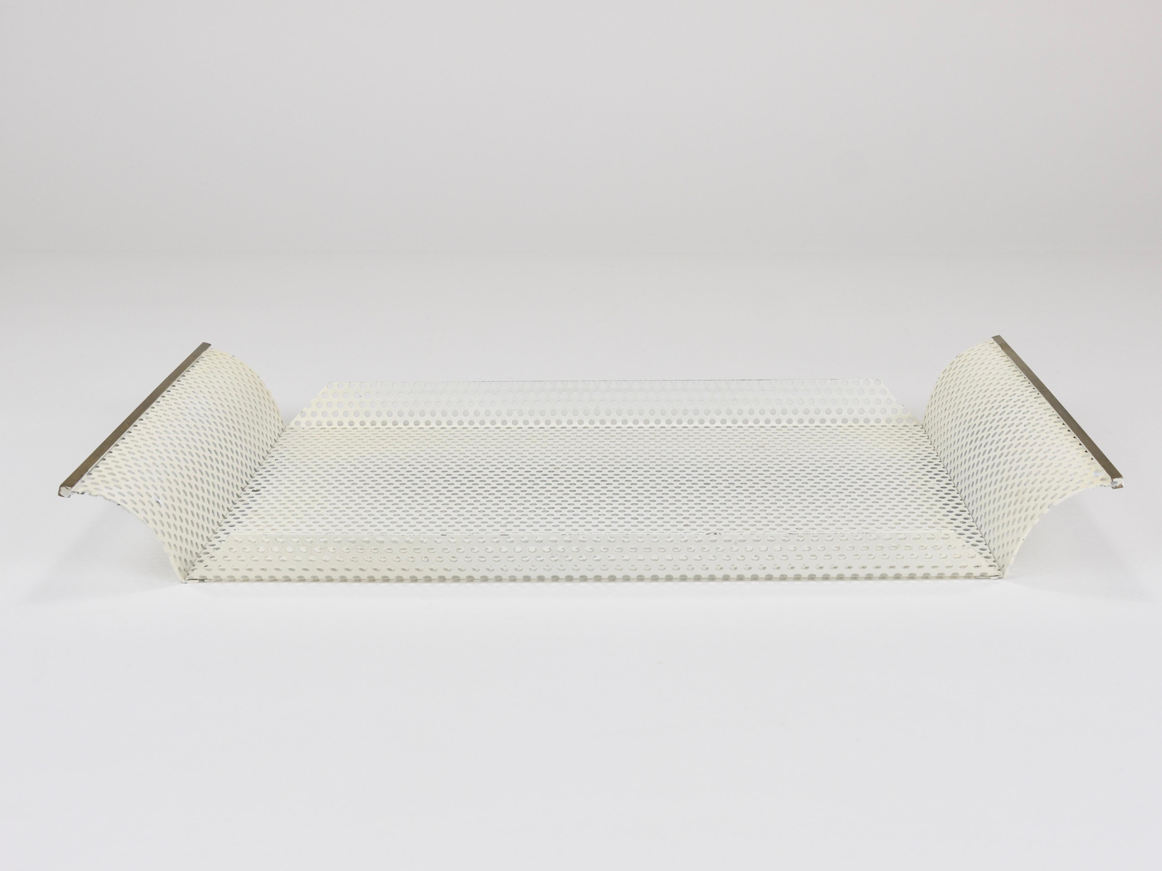 A minimalistic and elegant Mid-Century-Modern / Hollywood-Regency style rectangular tray from the 1970s, crafted by Vereinigte Werkstätten für Kunst und Handwerk, Munich, Germany. Made of perforated sheet metal with a cream-white / off-white finish