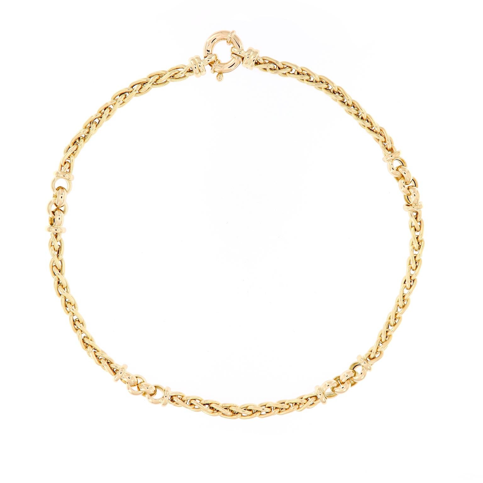 This beautiful Italian 14 karat yellow necklace features five woven gold link sections connected with larger round gold links. The necklace is 18 inches long and 5-8 mm wide. . 