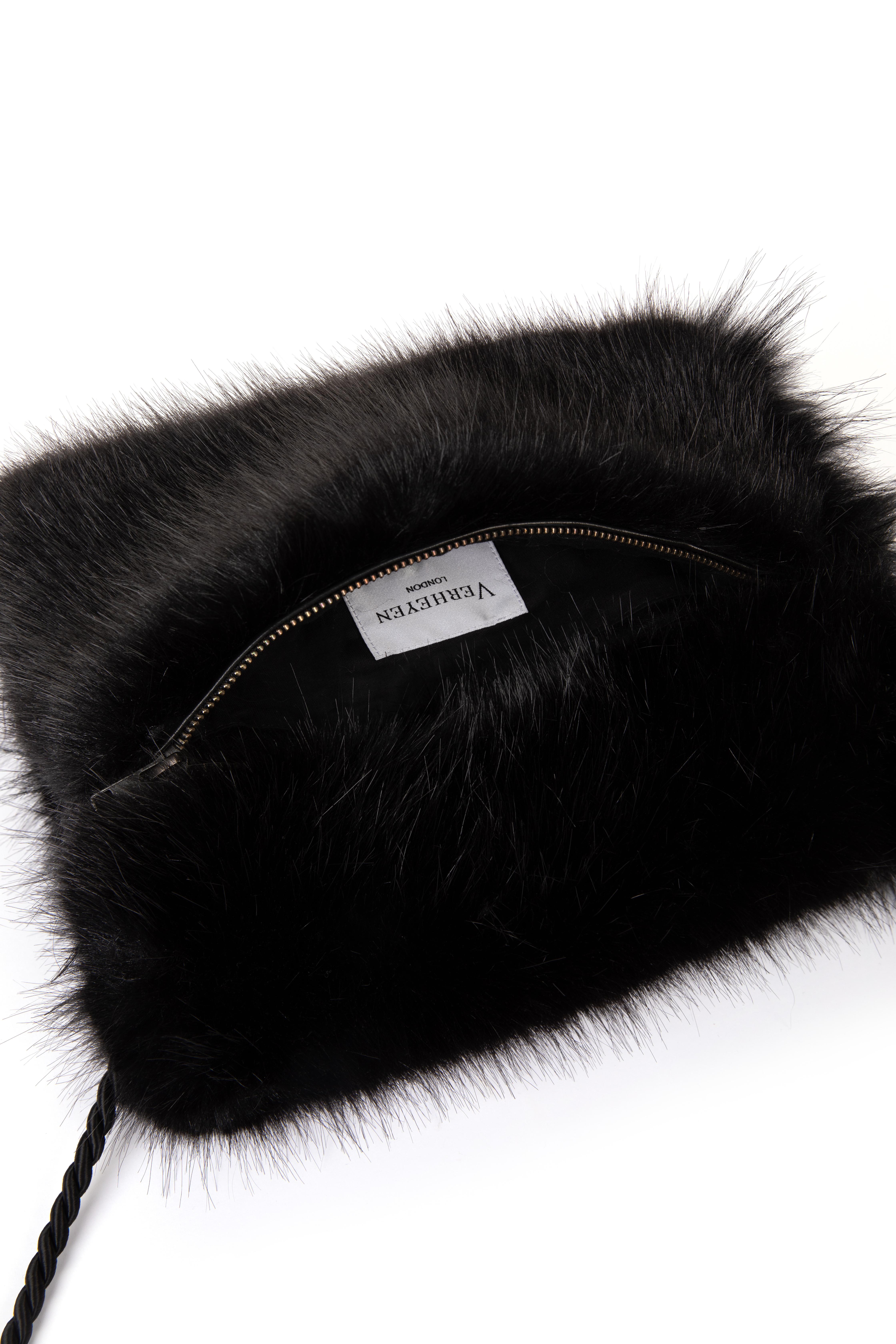 Verheyen London Faux fur Muff Handbag in Black

Handmade in London, made with luxurious faux fur, this bag will keep you cosy throughout the seasons.  Inspired by the muff bag introduced in the 16th Century as a purse for women and to keep their