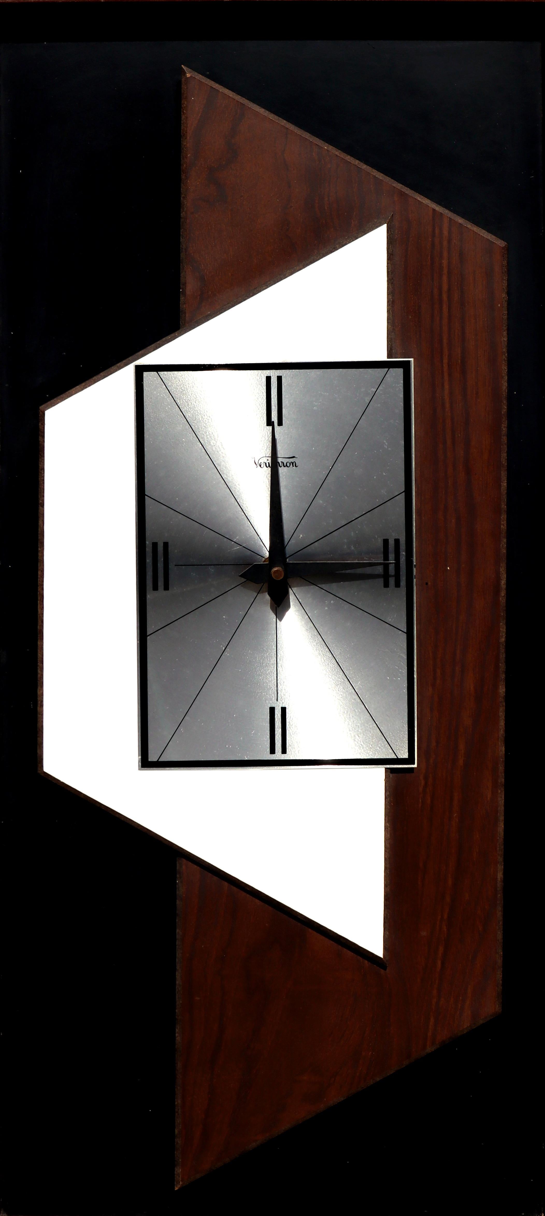 Mid-Century Modern Eames style wood and metal clock by Verichron. Model number and production information on verso 