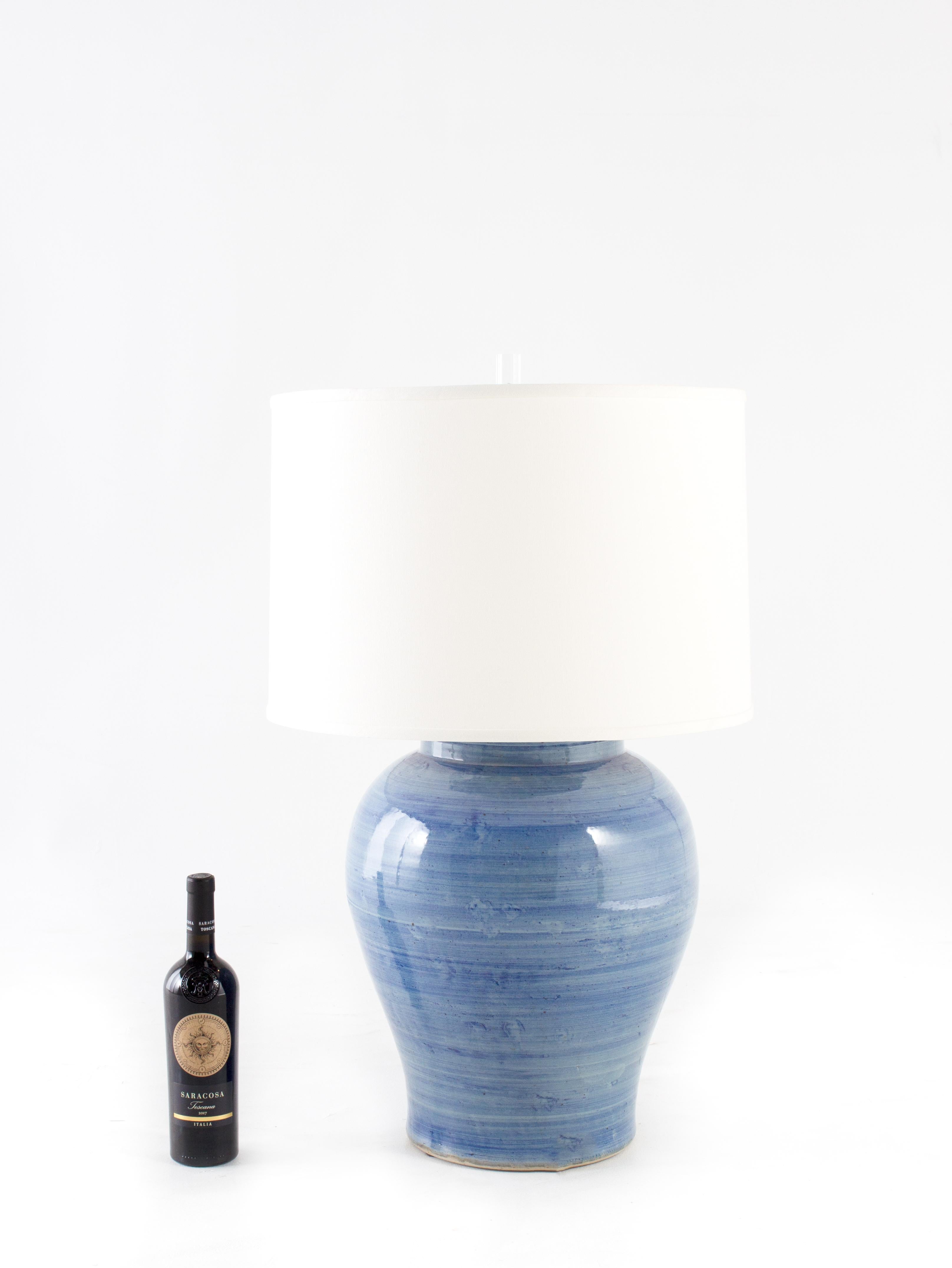 Verigated blue glaze jar lamp wired with linen shade.