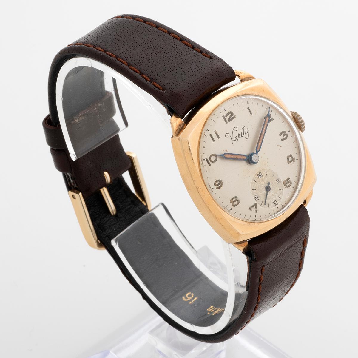 Our vintage manual wind Verity features a 9k yellow gold cushion case of 28mm inc crown and 30mm fixed lug to fixed lug. The attractive arabic numeral dial with sub seconds has some light patina and is coeval to the cathedral hands. A quality