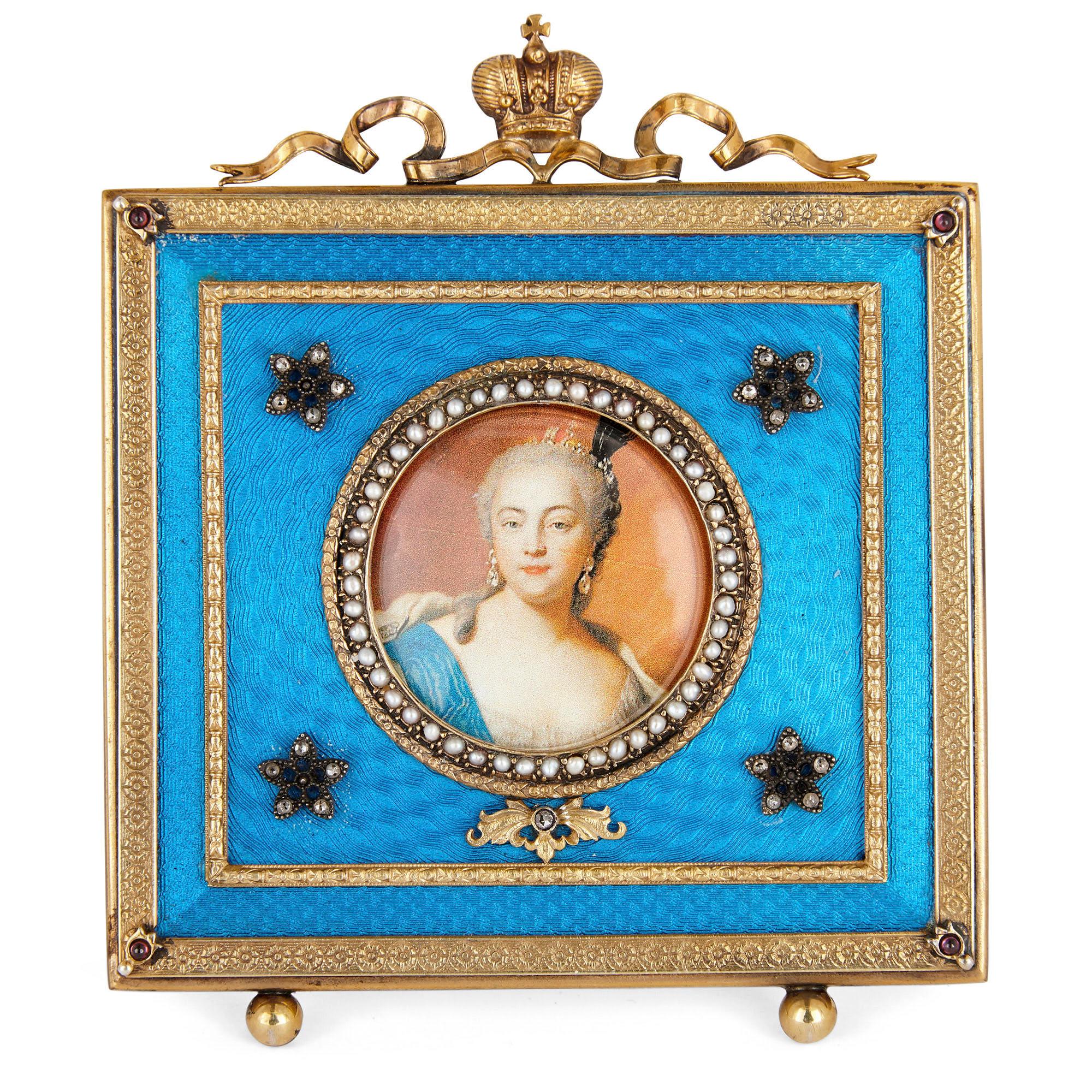 This picture frame is designed in the style of the famed Russian jeweller Fabergé. The frame is rectangular in profile with a surface profusely ornamented with brilliant blue guilloche enamel. The frame is edged along its exterior with vermeil (or