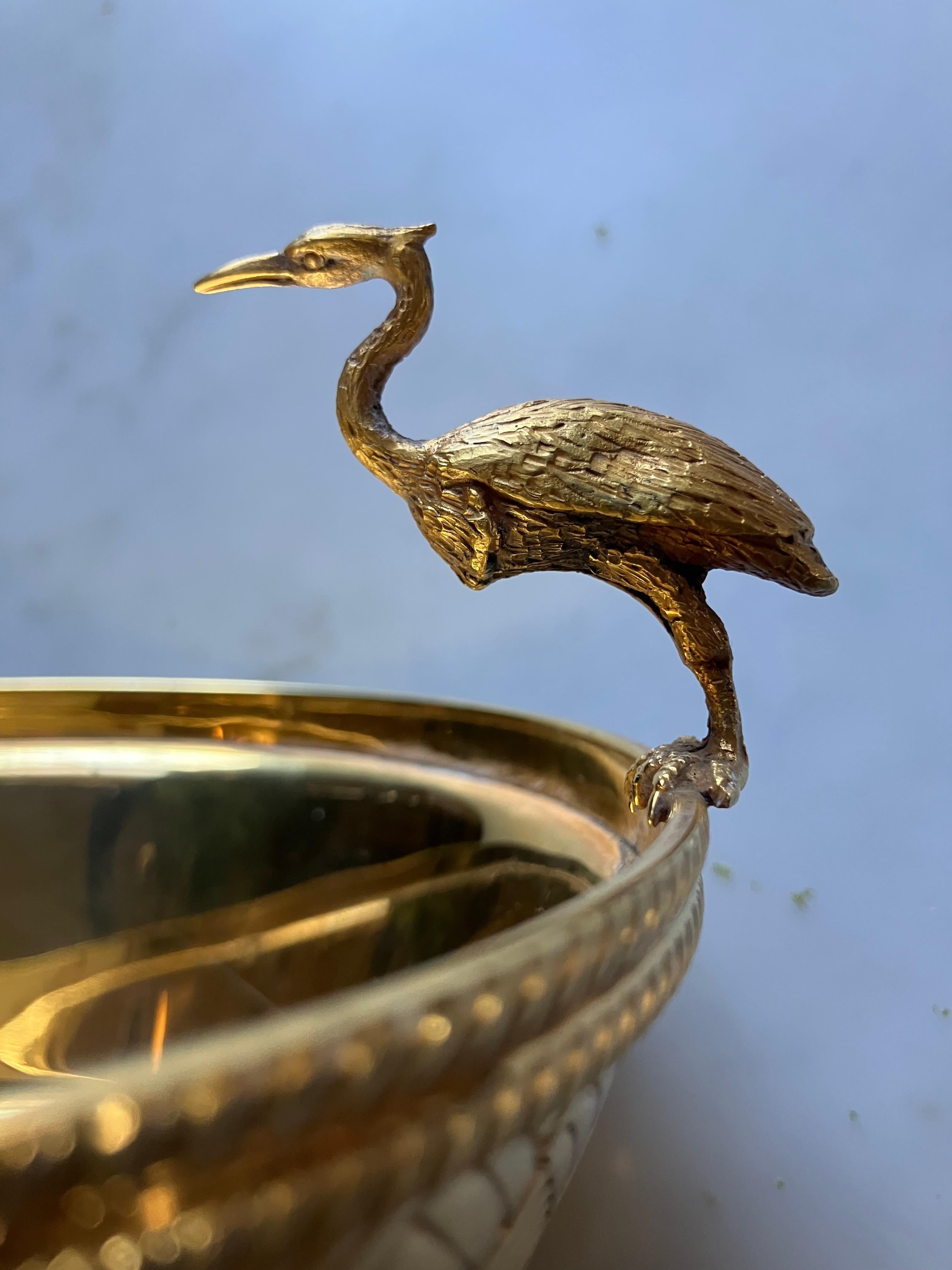 Vermeil heron bowl. Brilliant gilt silver bird bowl with basketweave sides and corded band roping with heron perched at rim. Silver hallmark 800 stamp markings. Italy, circa 1950's 
Dimensions: 5.25