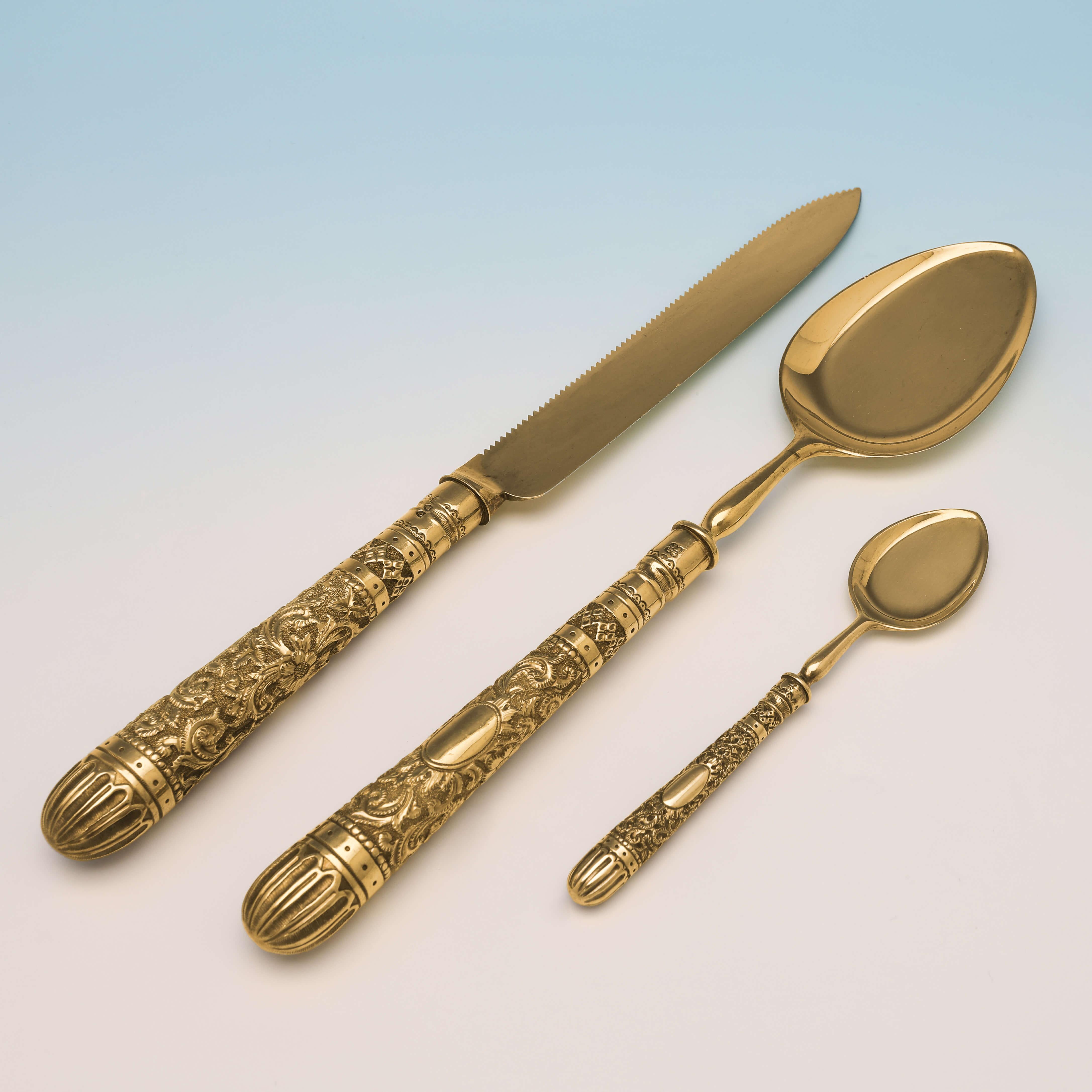 Hallmarked in London in 1881 by Aldwinckle & Slater, this very attractive, Victorian Antique Sterling Silver Set of Ice Cream Spoons Is presented in the original box along with a serving spoon and serrated cake knife, all ornate in design, and gold