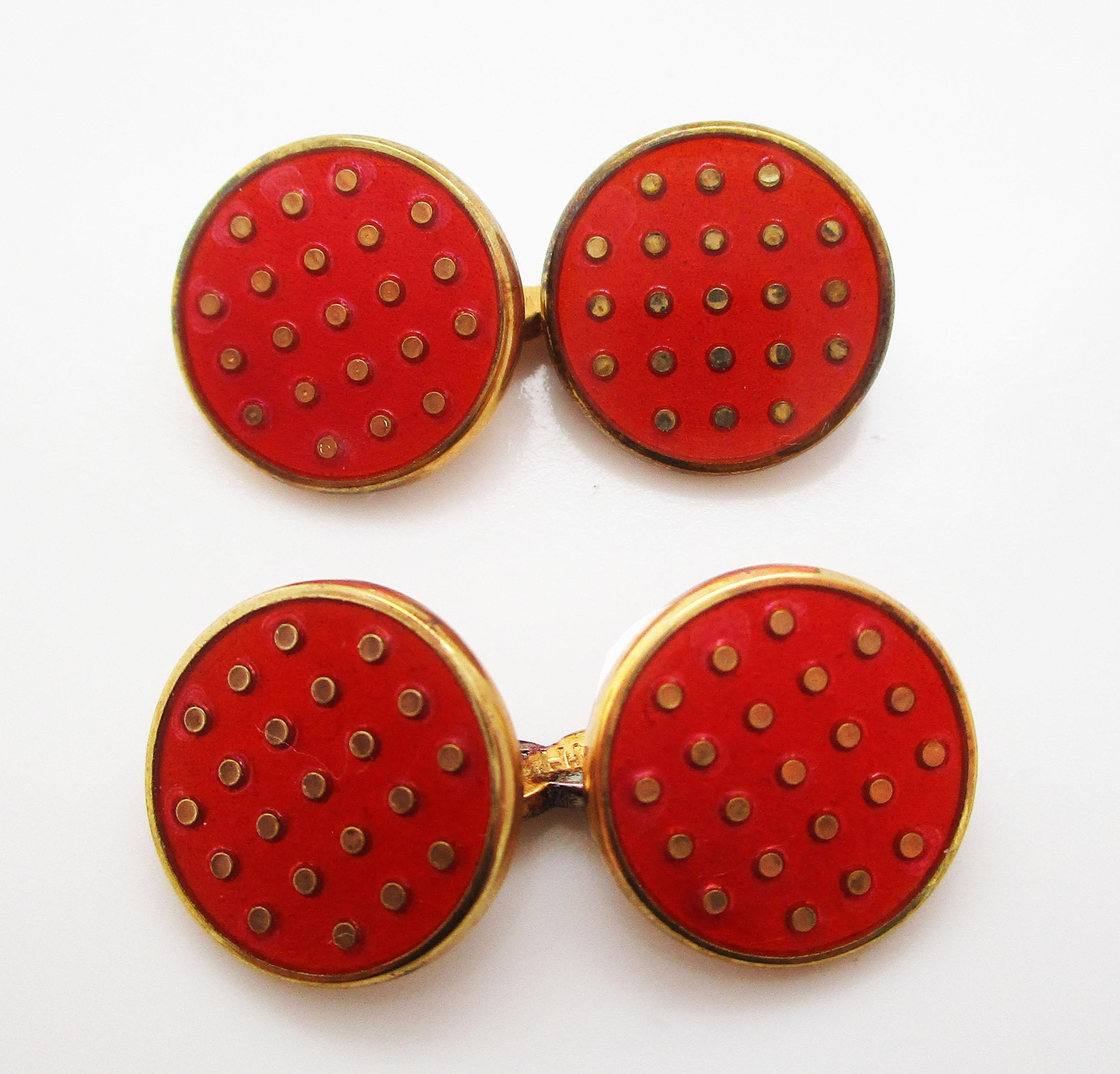 This is a gorgeous pair of contemporary cufflinks in vermeille with a  bright and sophisticated red enamel polka dot pattern. The links have a simple round shape accented by a gold border that separates the enamel panel from the sleeve upon which it