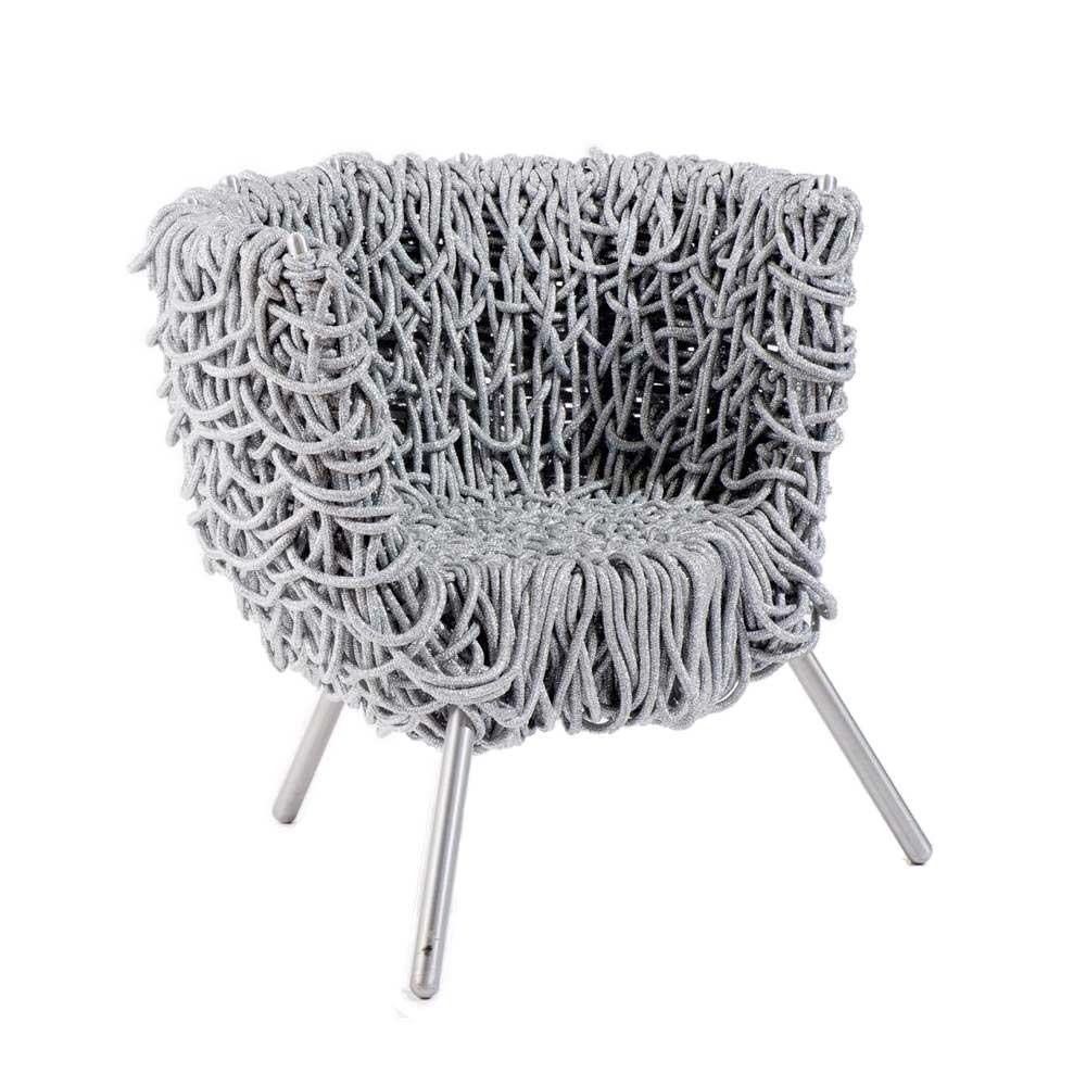 Using a simple steel frame, the Vermelha lounge chair is composed of 500 meters of special silver rope with an acrylic core that is twisted hundreds of times to overlap in engaging and seemingly chaotic ways. This labor-intensive design is created