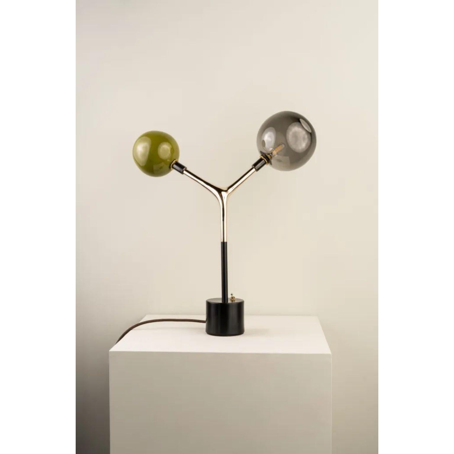 Olive and Smoke Mácula Table Lamp by Isabel Moncada
Dimensions: D 28 x W 46 x H 53.5 cm.
Materials: Cast bronze body, turned brass base, colored blown glass globes and rayon-lined cable.

Mácula, the organic and asymmetrical shape provides a simple