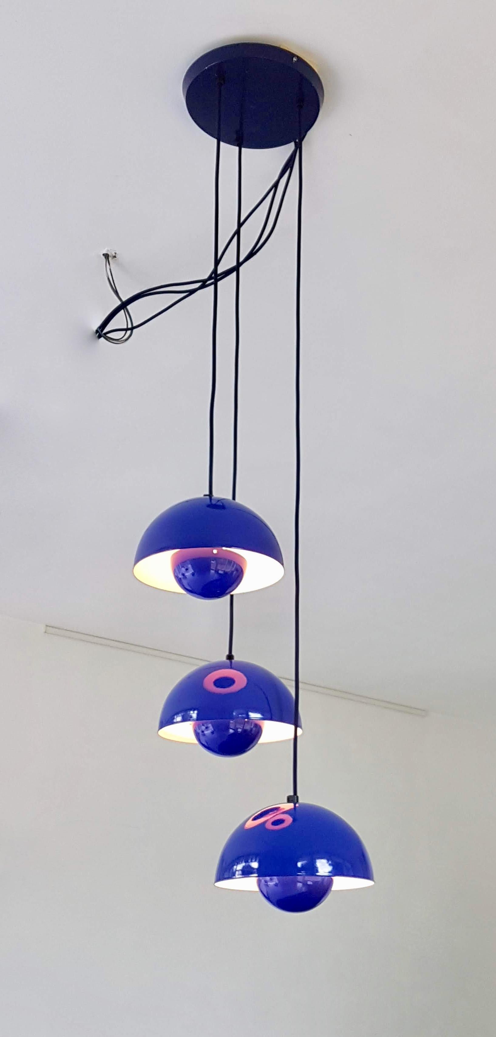 'Flower Pot chandelier by Verner Panton consisting of three mounted iconic 'Flower Pot' lamps.
The flower pot, with its two enameled steel semicircular spheres facing each other, is a brilliant colourful design that was originally designed in 1968