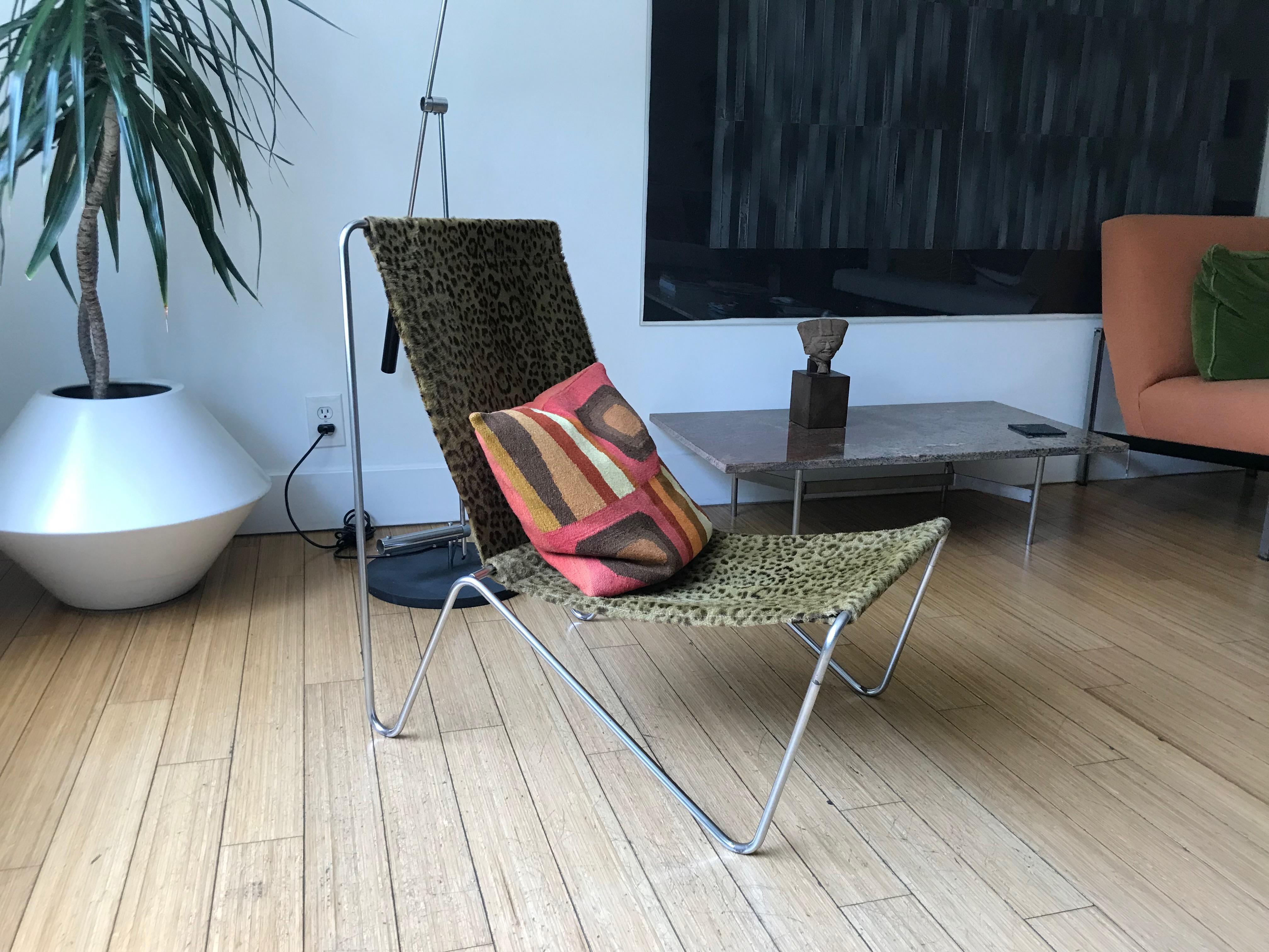 Simple and handsome modernist design.
Architectural steel form with the original leopard skin / leather sling seat. 
It has minor surface rust in between the bends at the base.
Nice patina.
No damage.
Solid and sturdy.
Great for occasional