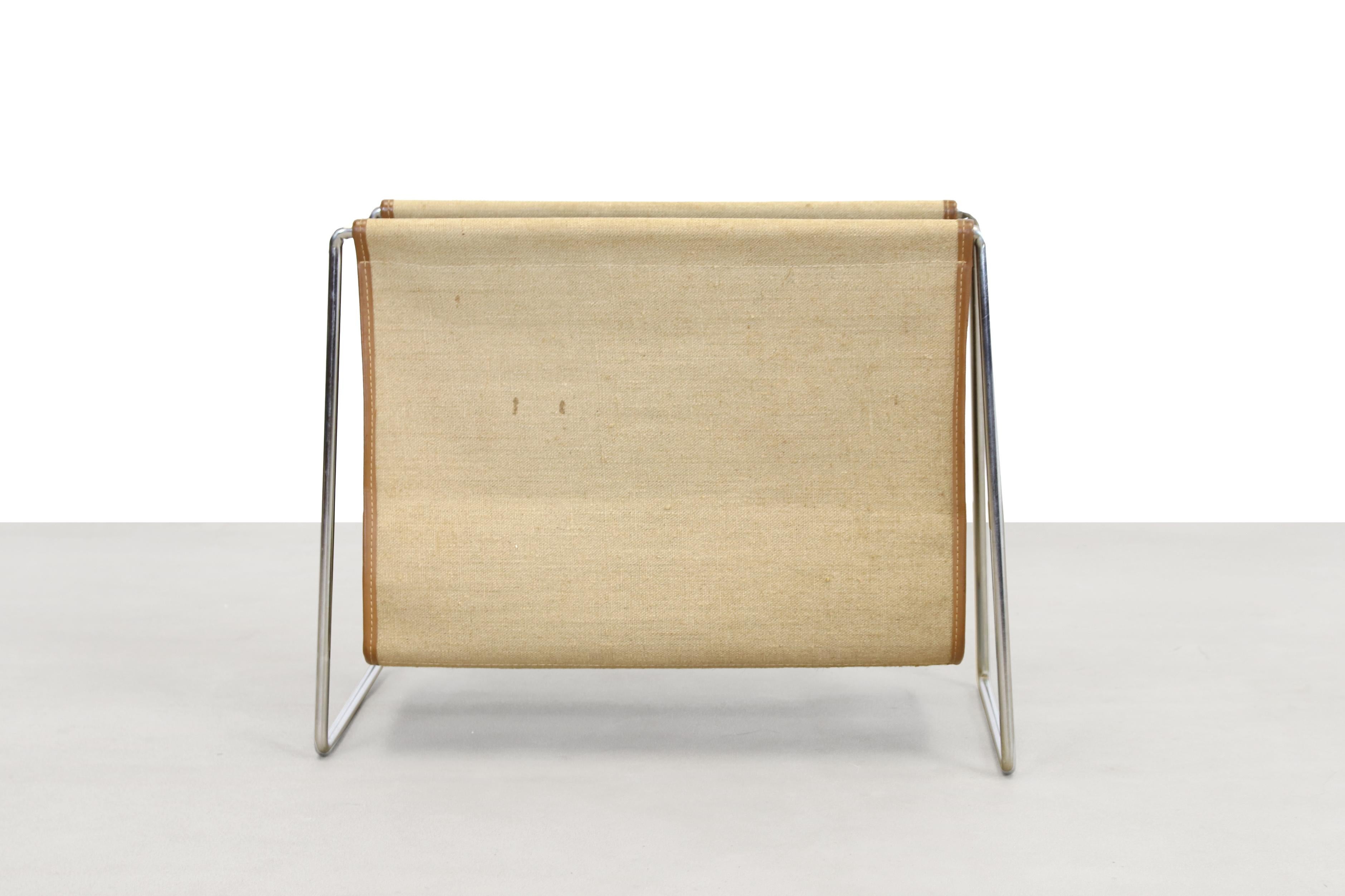 Beautiful canvas magazine holder designed by Verner Panton and produced by Fritz Hansen in Denmark. This magazine rack is made of bent chromed steel tubes and canvas with leather. 
Very minimalist and timeless design by a great Danish designer.