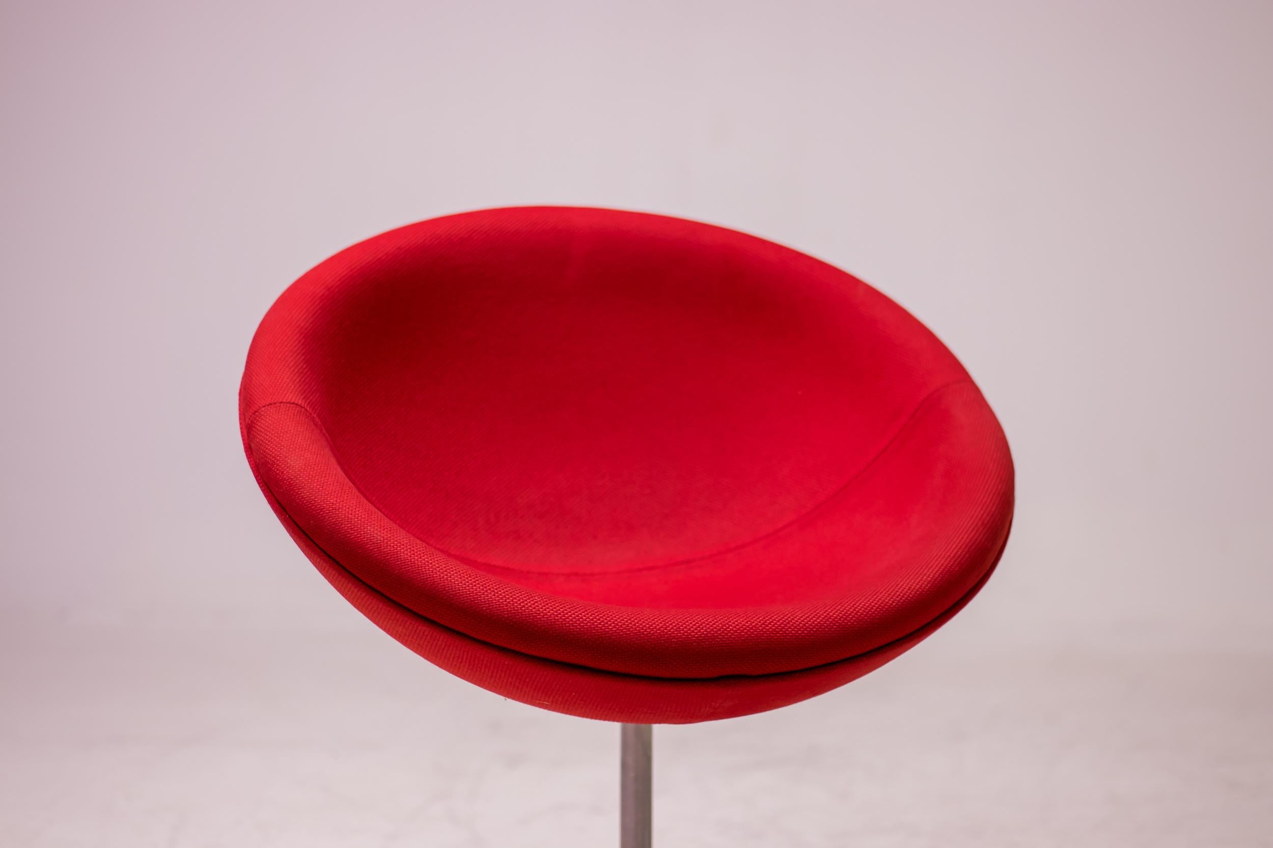 Iconic red C1 armchair designed by Verner Panton and manufactured by Vitra. On swivel bearings and slightly tilted, the upholstered seat shell is comfortable - both for relaxed sitting leaning back and for upright sitting. The C1 can be integrated