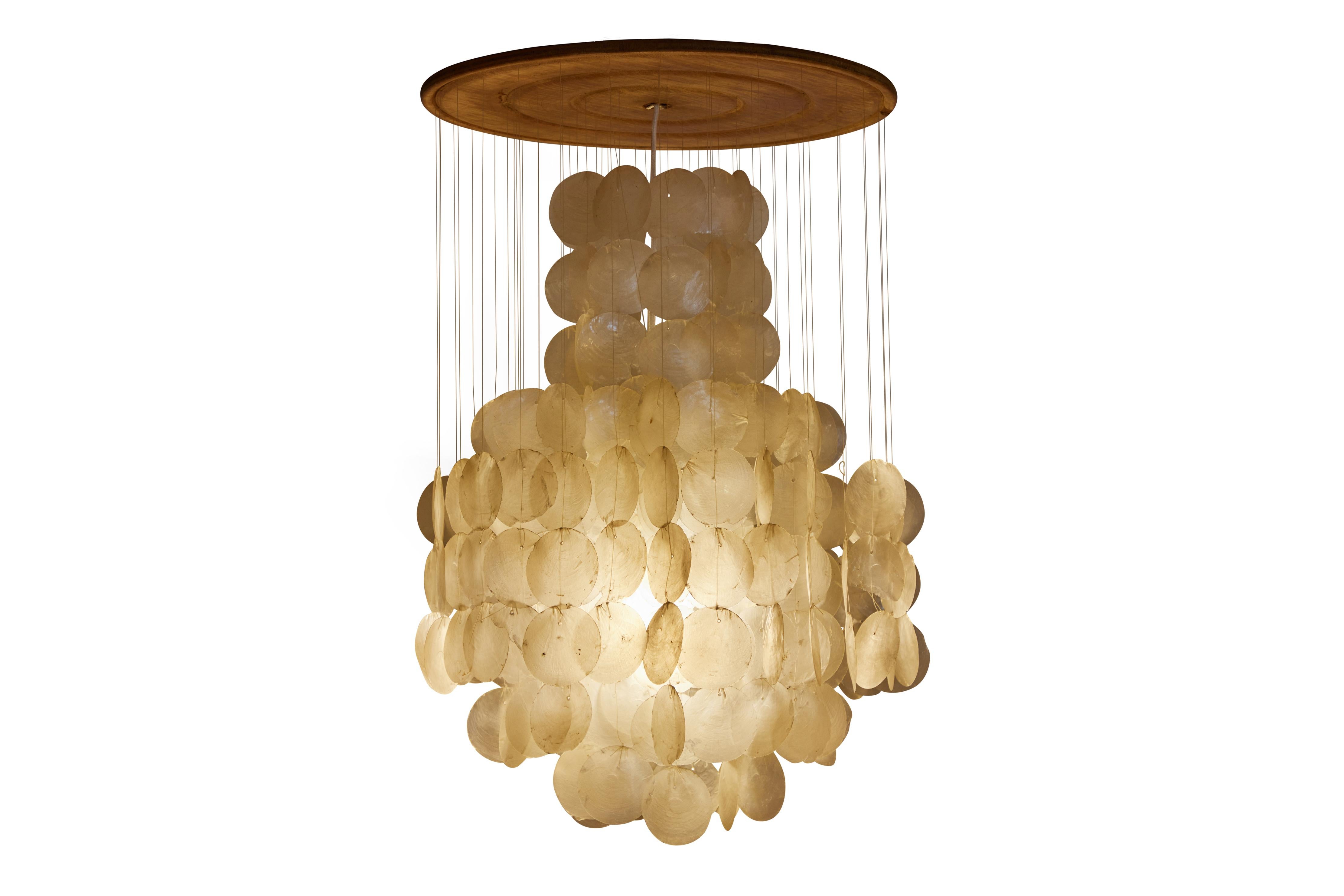 Vintage capiz shell pendant light attributed to Verner Panton circa 1960s.This pendant has a wooden mount piece and one tier of hanging capiz shell discs.