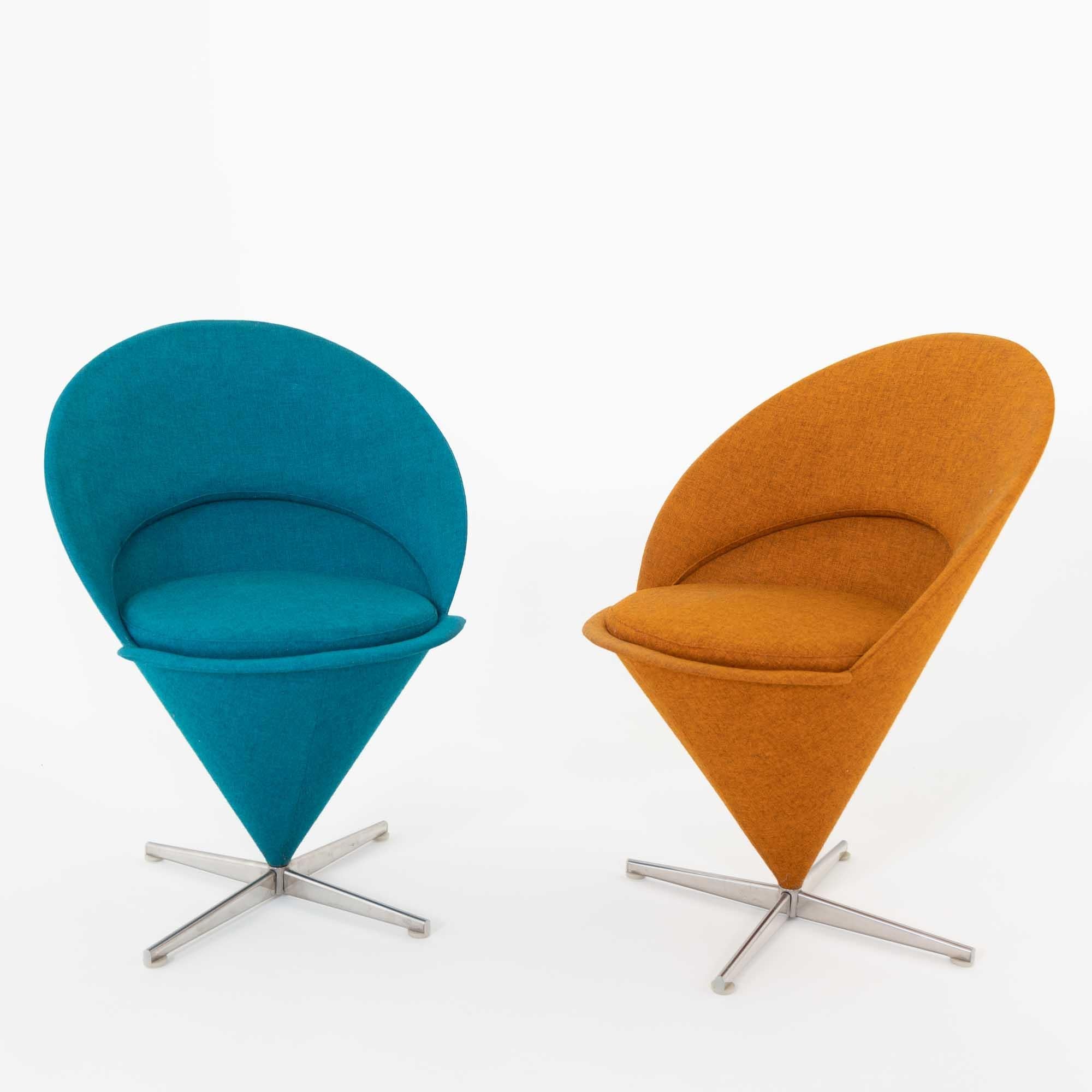 Two Cone chairs by Verner Panton on x-shaped aluminium frame and conical form with round seat and high backrest. One chair with orange, the other with blue cover.