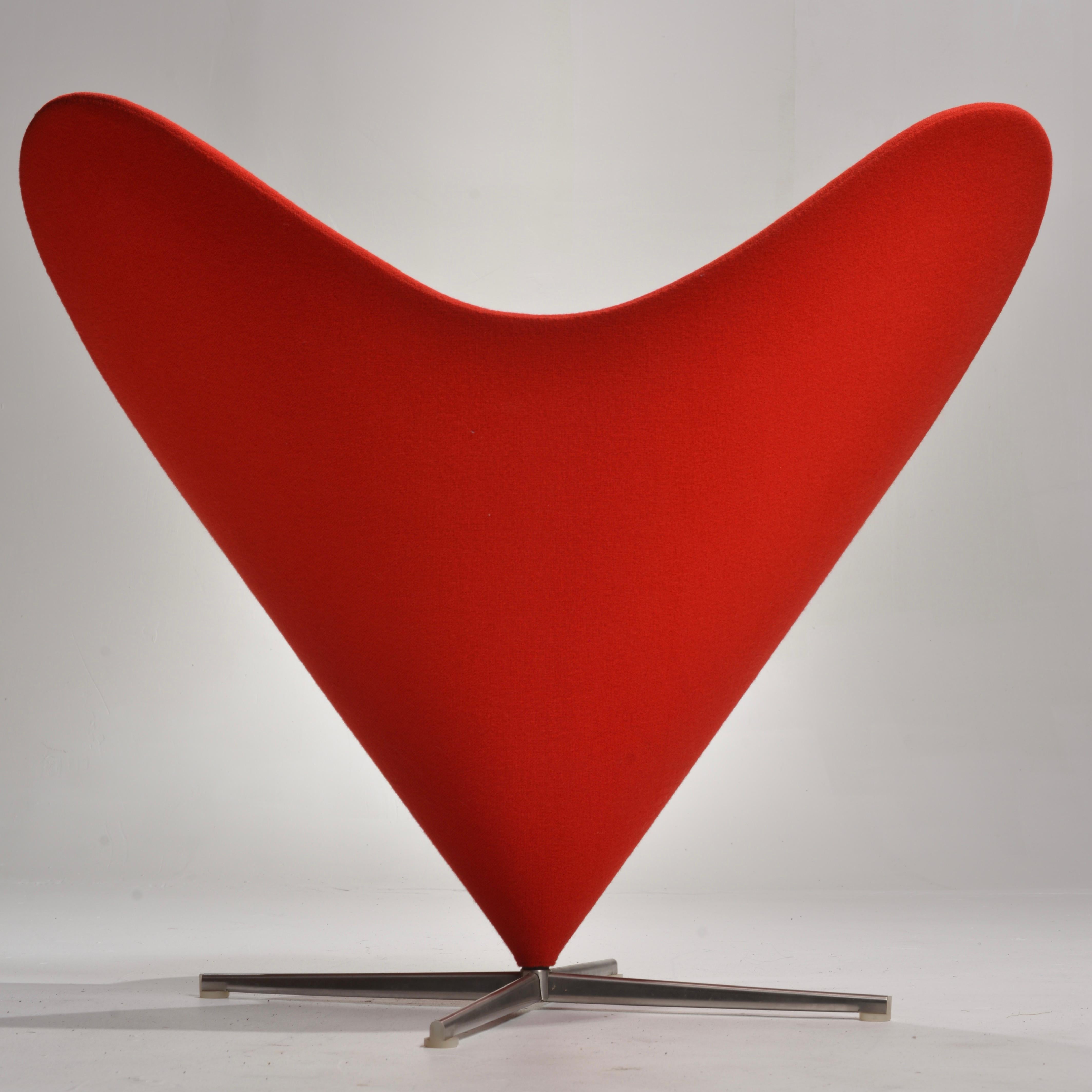 This classic and distinctive red heart cone chair was designed by Verner Panton in 1958. Verner Panton was an influential designer during the 1960's and 70's. His masterful use of color was one of his trademarks. He had a passion for bright colors