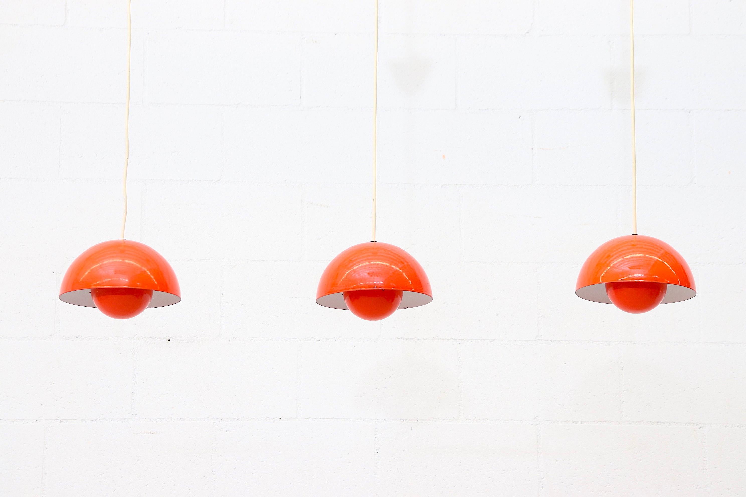 Midcentury Verner Panton flower pot pendant light for Louis Poulsen in 1969, Denmark with Dual orange enameled shades. Designed in the 1960s the shades are connected by metal hooks to complete its futuristic style. In original condition with minimal