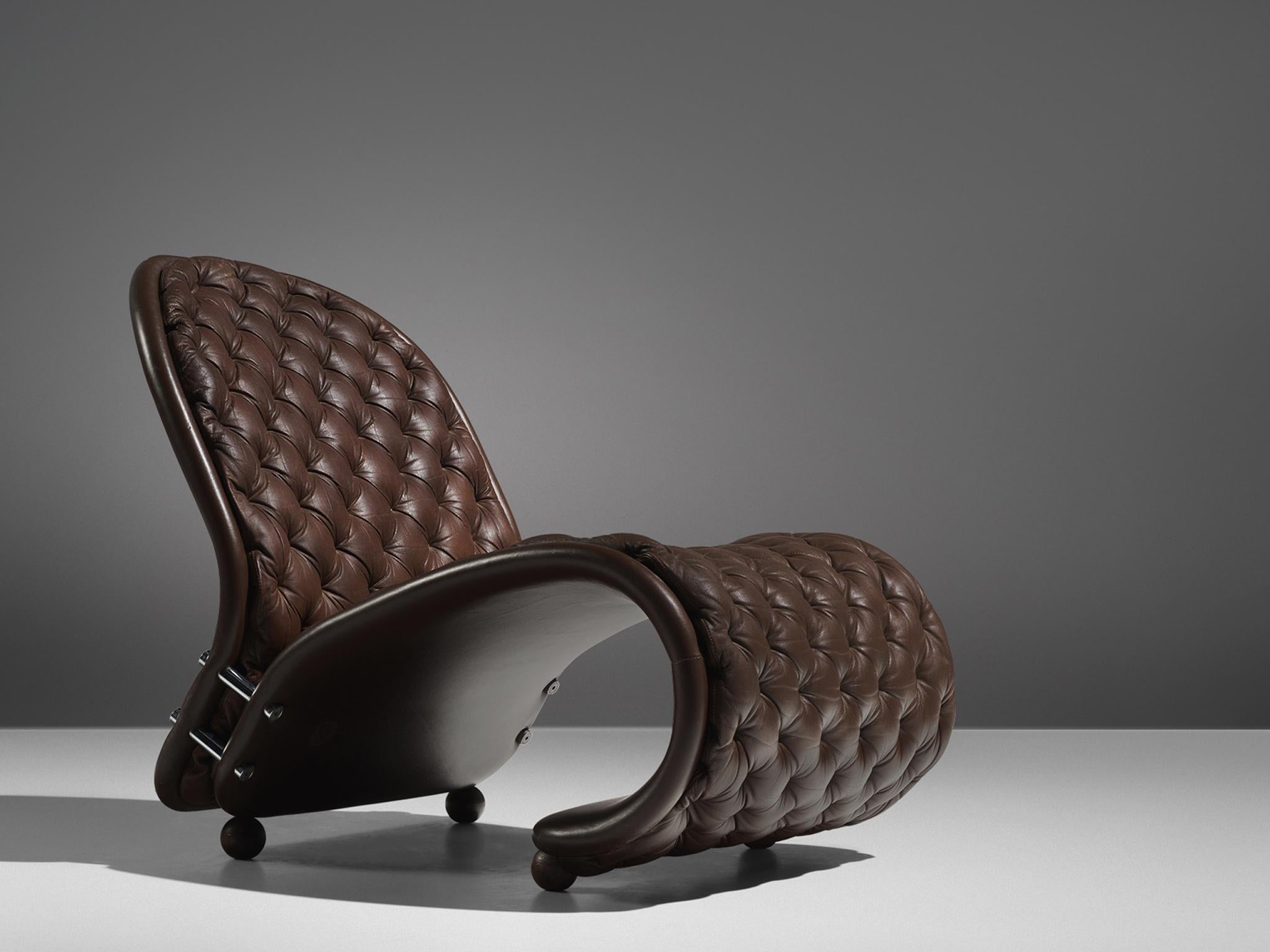 Verner Panton for Fritz Hansen, lounge chair model G, brown leather, Denmark, 1973
 
Iconic lounge chair by Vener Panton in 1973. The ‘G’ lounge chair shows the dynamic that Panton’s designs are famous for. Two curved parts are held together by