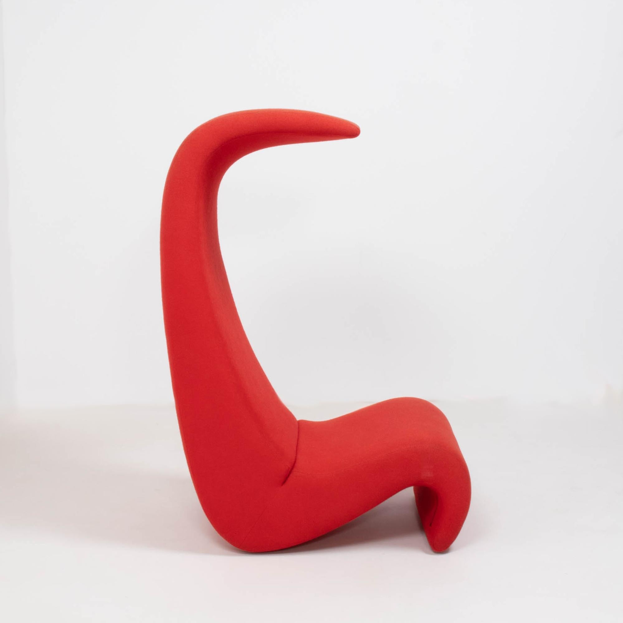 Originally designed by Verner Panton in 1970, the Amoebe Highback chair was created for the Visiona installation and has become a design icon.

Upholstered in bright red fabric, the sinuous curves create a bold and sculptural silhouette which also