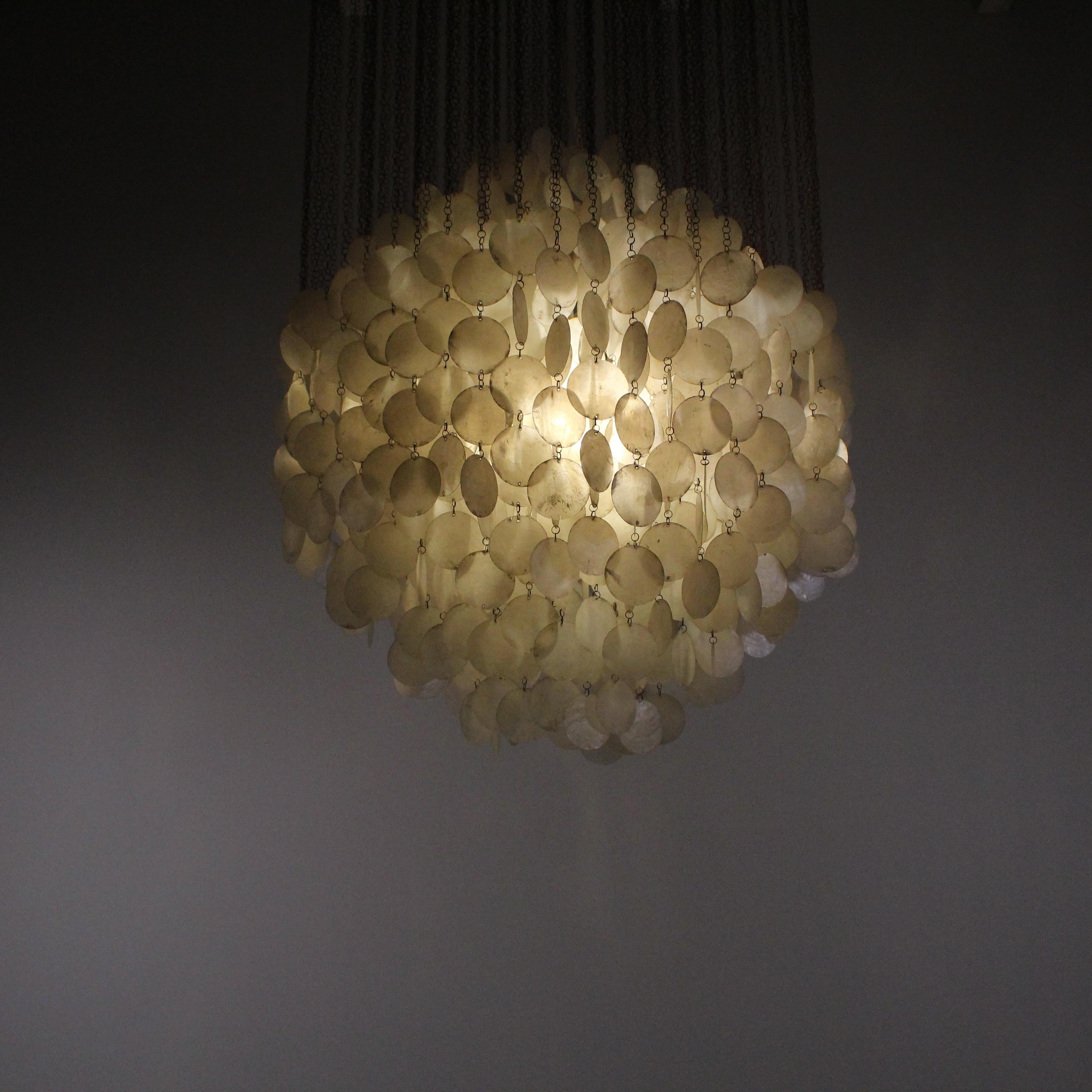 This meticulously crafted chandelier is a testament to Panton's iconic design ethos. The cascading layers of seashells create a dynamic interplay of light and shadow, delivering a striking visual impact. This chandelier transcends traditional