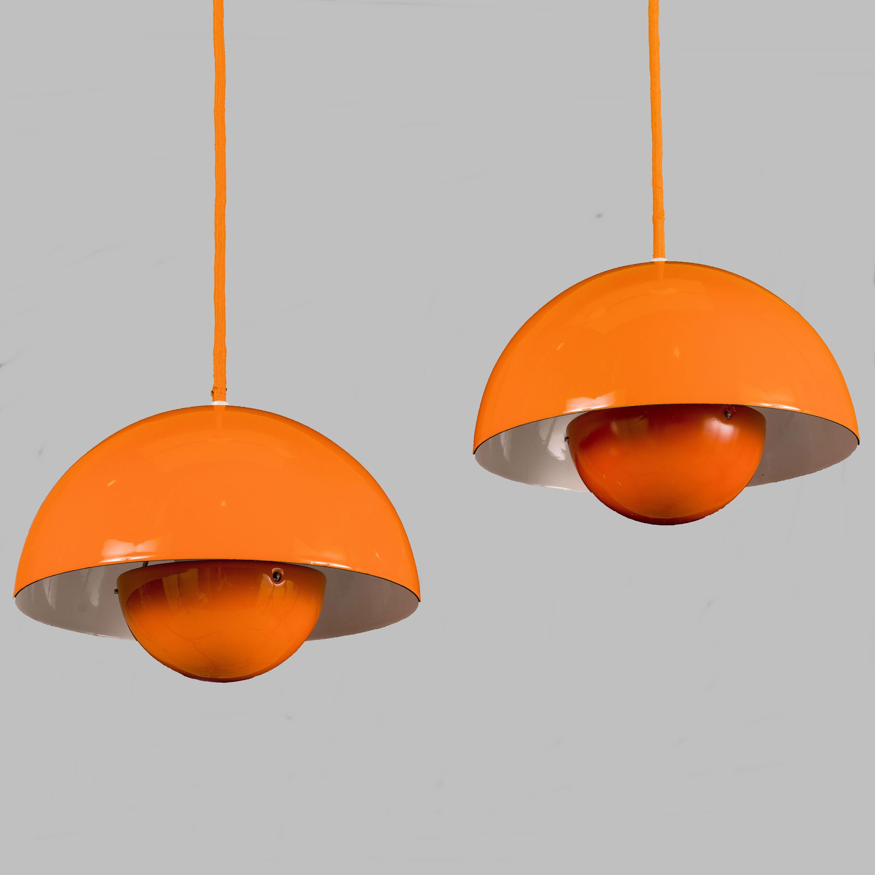 Verner Panton pair of first edition Danish flowerpot pendants by Louis Poulsen designed for Louis Poulsen in 1969.

This set of two orange or yellow pendant lights are the early Enamel version of the Panton flowerpot model and feature an orange