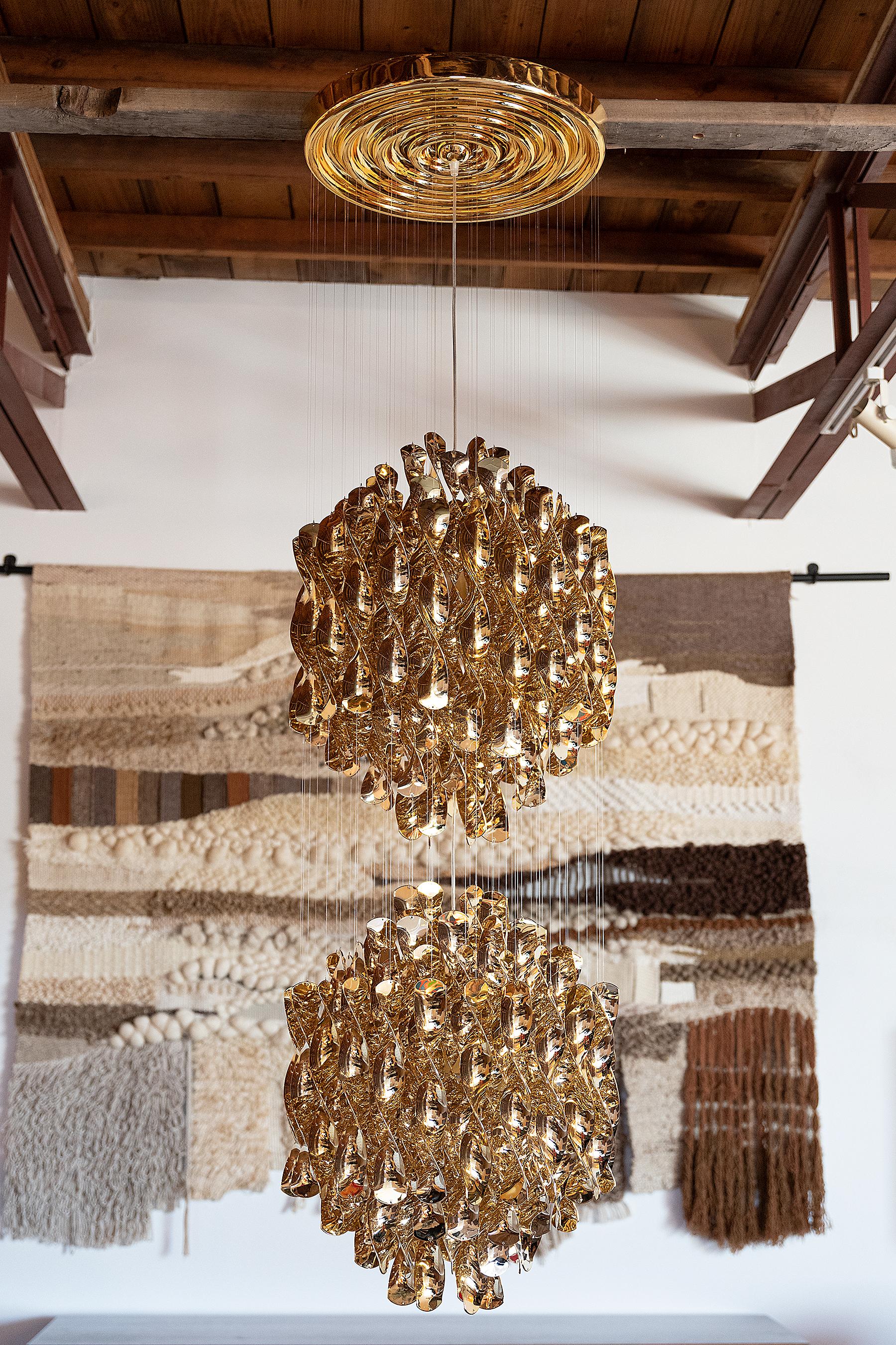 Phenomenal Spiral Chandelier designed by Verner Panton in 1969 and produced by Verpan in the metallic Gold Finish. The spirals move with the natural airflow in the room creating a hypnotic effect that inhibits your depth perception while looking at