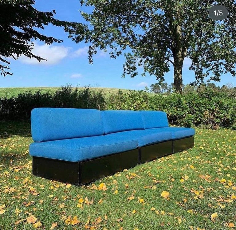 Three early Verner Panton ‘Studioline’ sofa /daybed modules designed in 1961 and produced by France & Søn. Black frame with legs in front and wheels behind. Cushions in blue wool. Storage under the seating. L. 100 D. 67 cm. Has a little patina, but