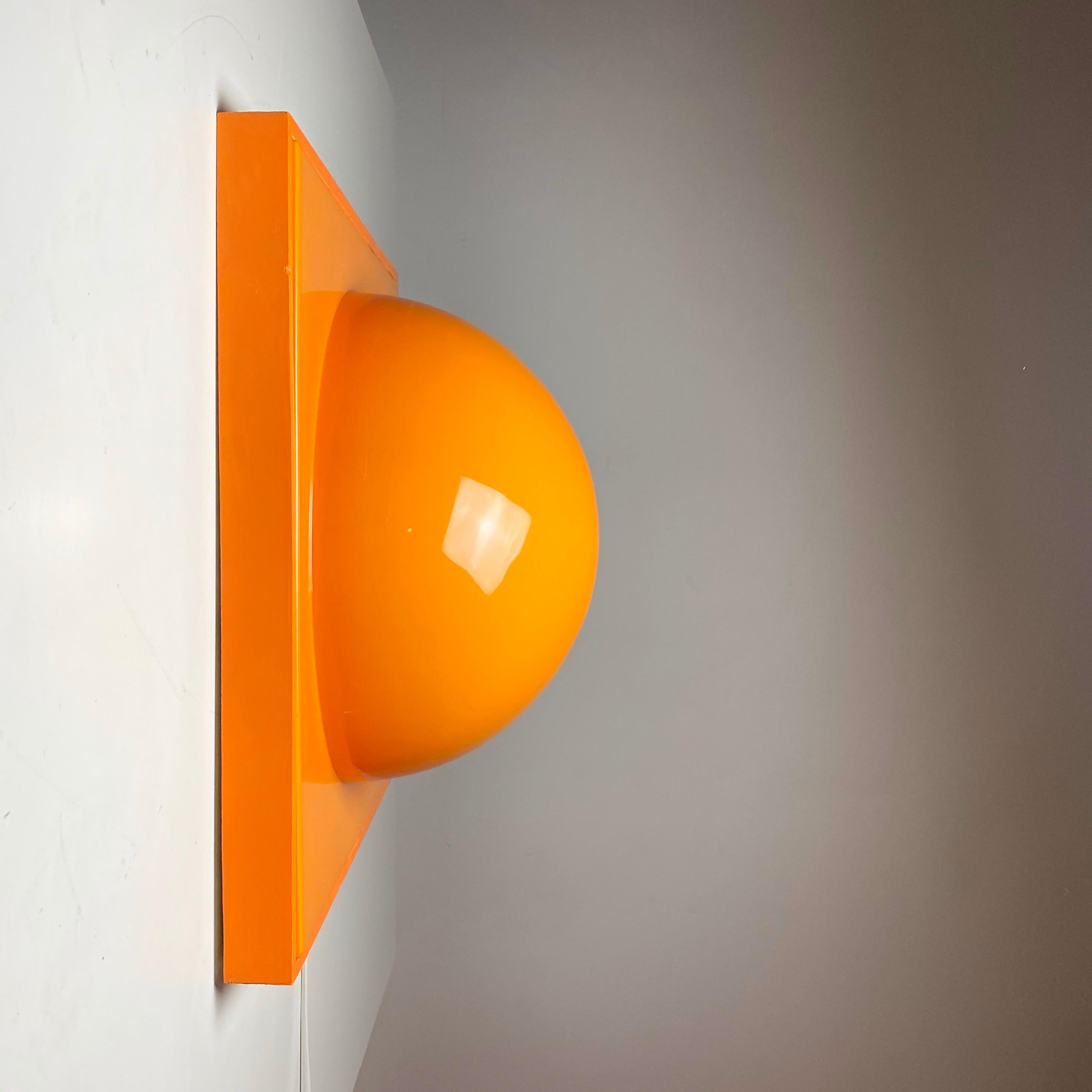 Sculptural designed wall light made in the 1990s and handmade fabricated wooden frame. The mold used is the same as Verner Panton used to produce his wall panels for the design exhibition Visiona 2 in 1970.

Made from orange plastic and wooden