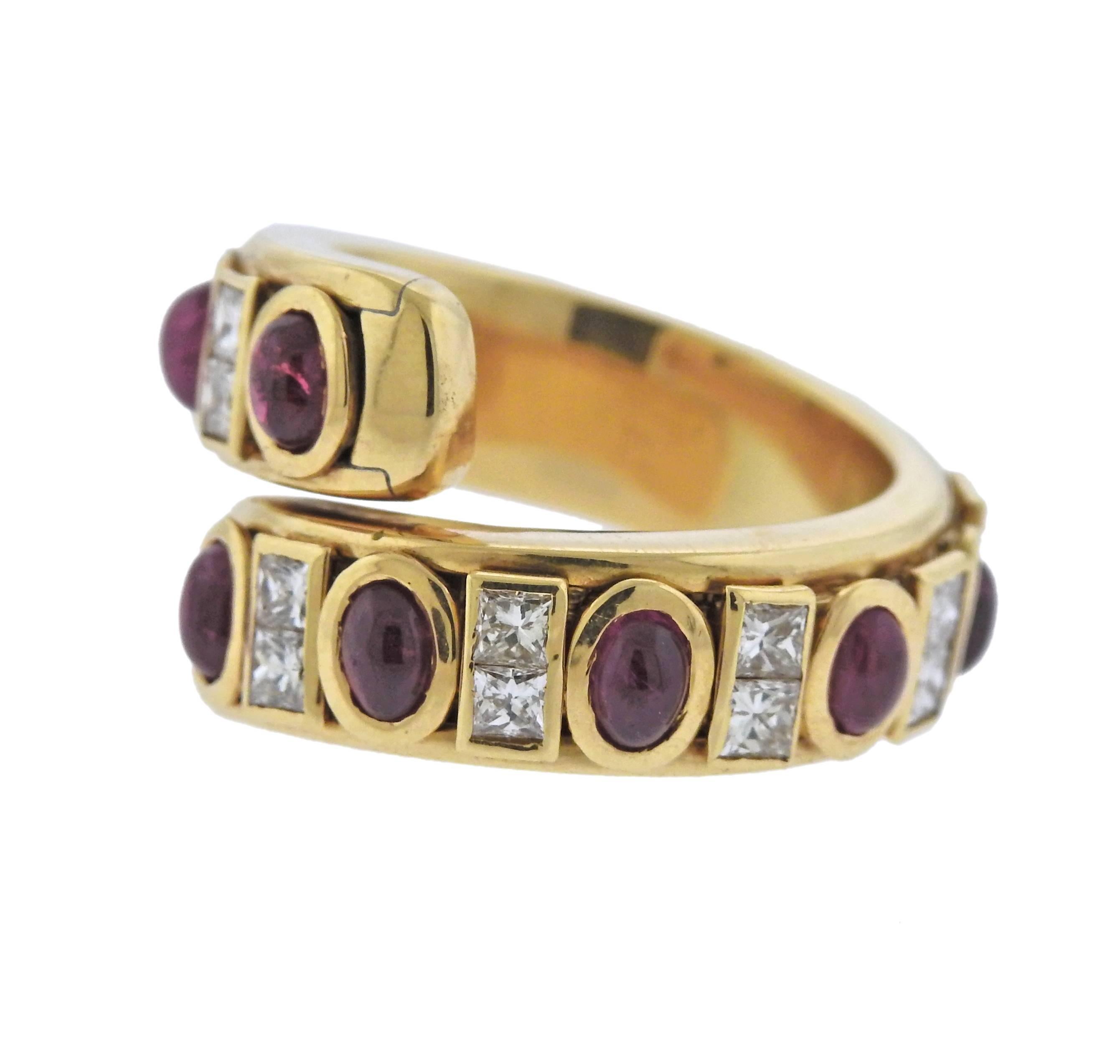 18k yellow gold bypass ring, crafted by Verney Paris, decorated with approx. 1.00ctw in diamonds and rubies. Ring size - 6, ring top is 14mm wide, weighs 13.1 grams. 