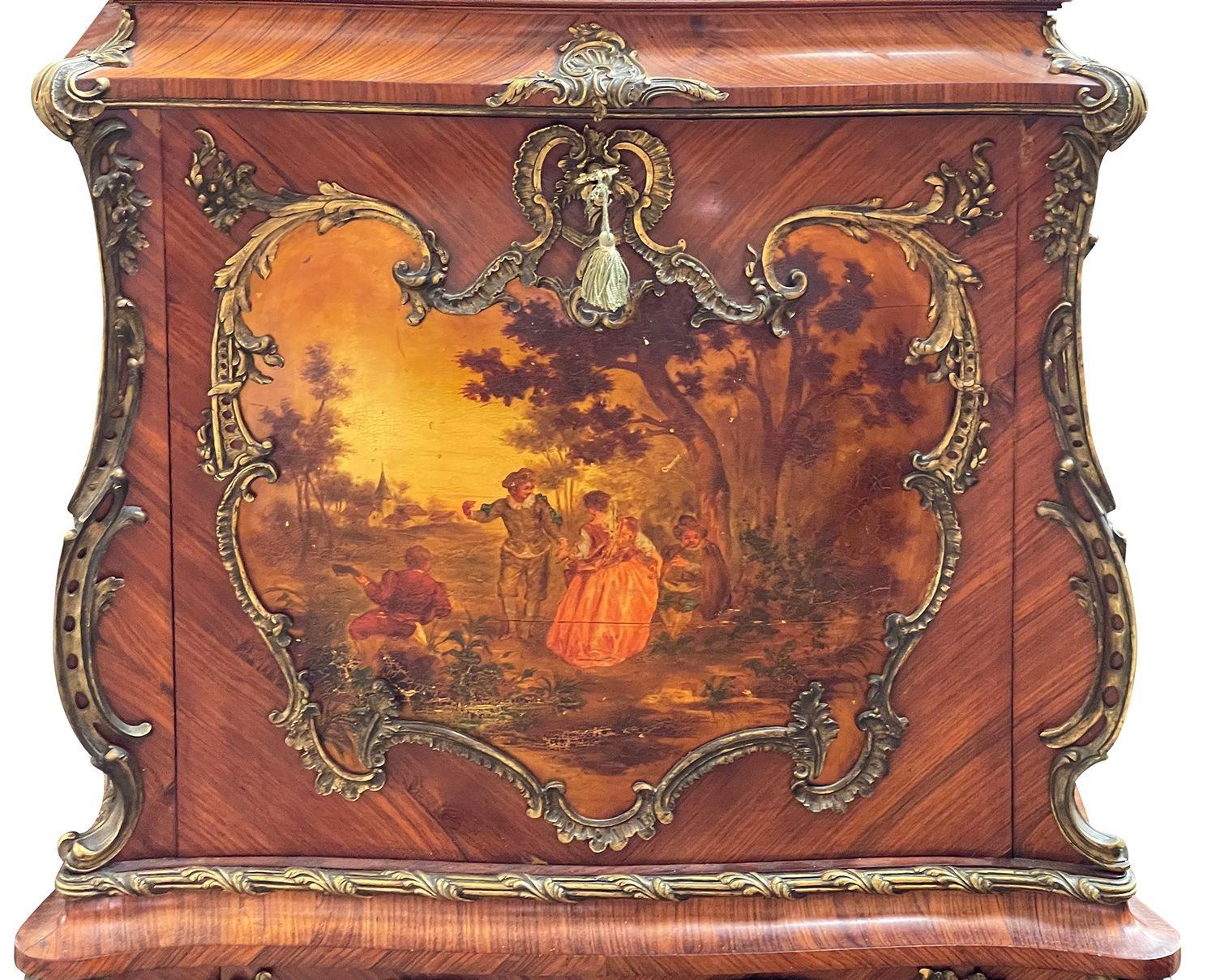 A very good quality late 19th Century French Louis XVI style secretaries abbattant, having bombe shaped sides, gilded rococo style scrolling ormolu mounts. Wonderful hand painted Verni Martin romantic to the centre of the fall, opening to reveal