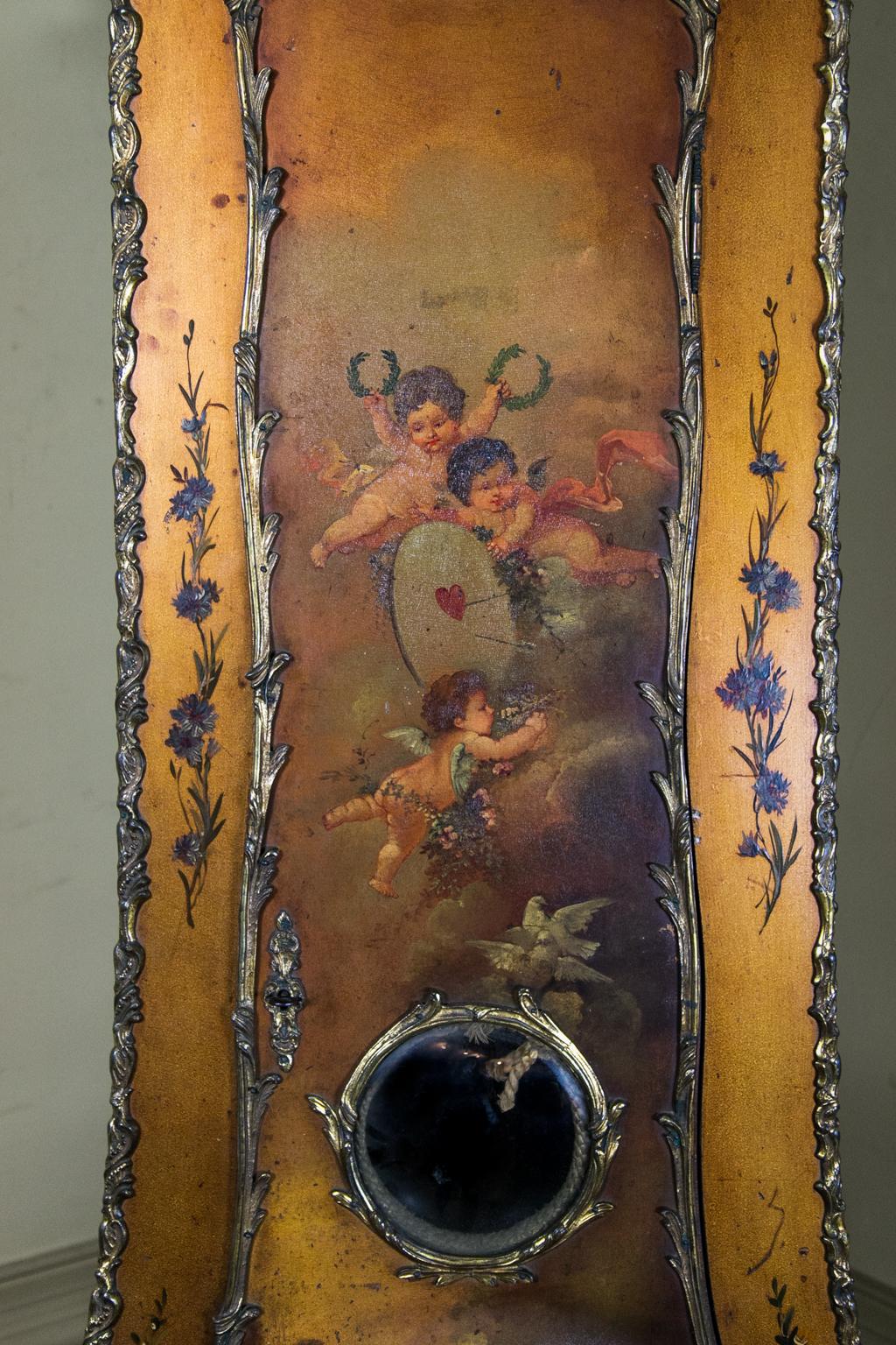 Vernis Martin style grandfather clock, with the front and sides richly embellished with ormolu mounts. The door is painted with cupids holding wreaths and doves surrounding a convex glass pendulum door. The sides have elaborate floral, musical, and
