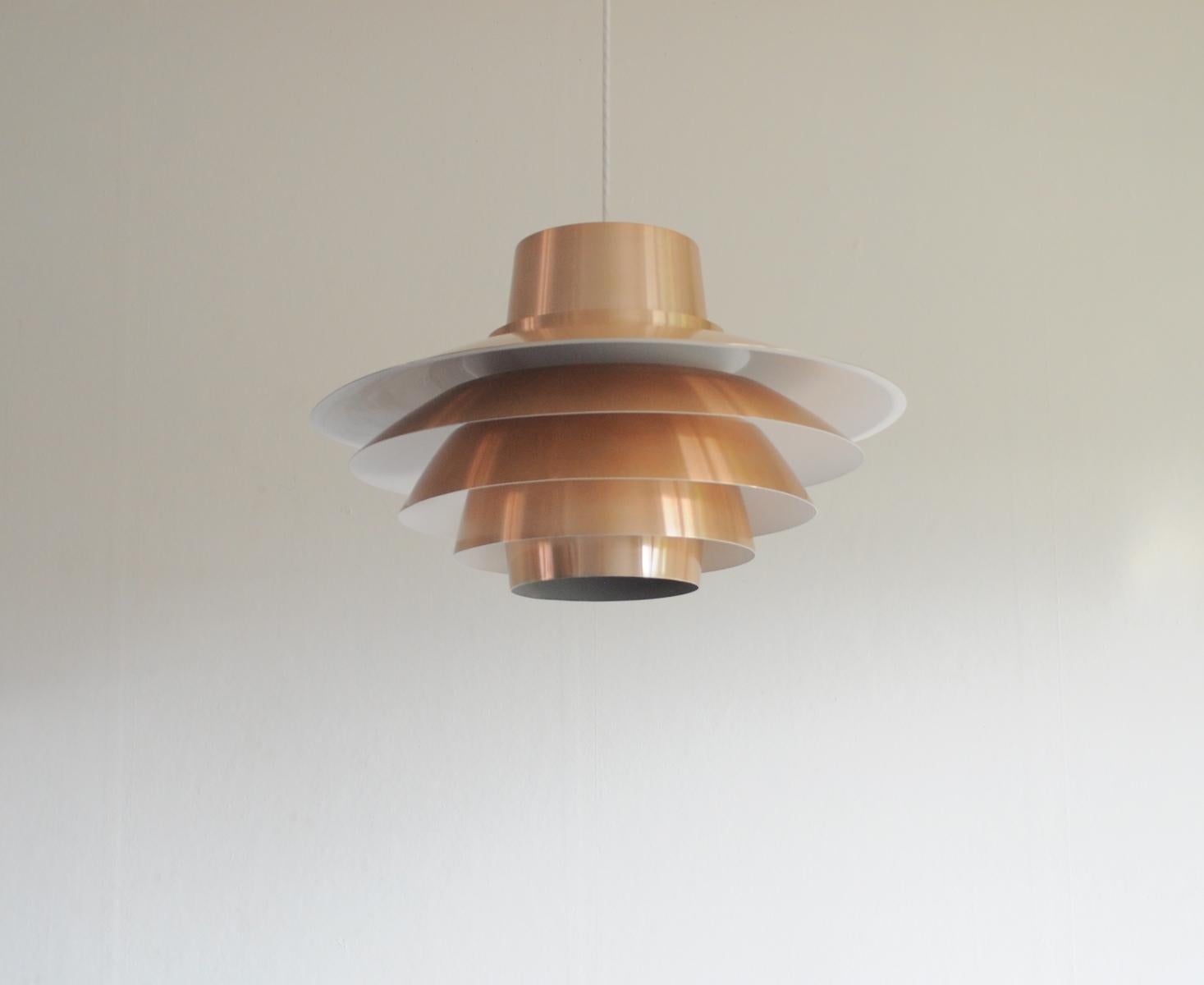 The copper model Verona pendant light was designed by Sven Middelboe and produced by Nordisk Solar in the 1970s. It is constructed from tiers of aluminum which have a copper coating.

Signs of wear consistent with age and use, small scratch see