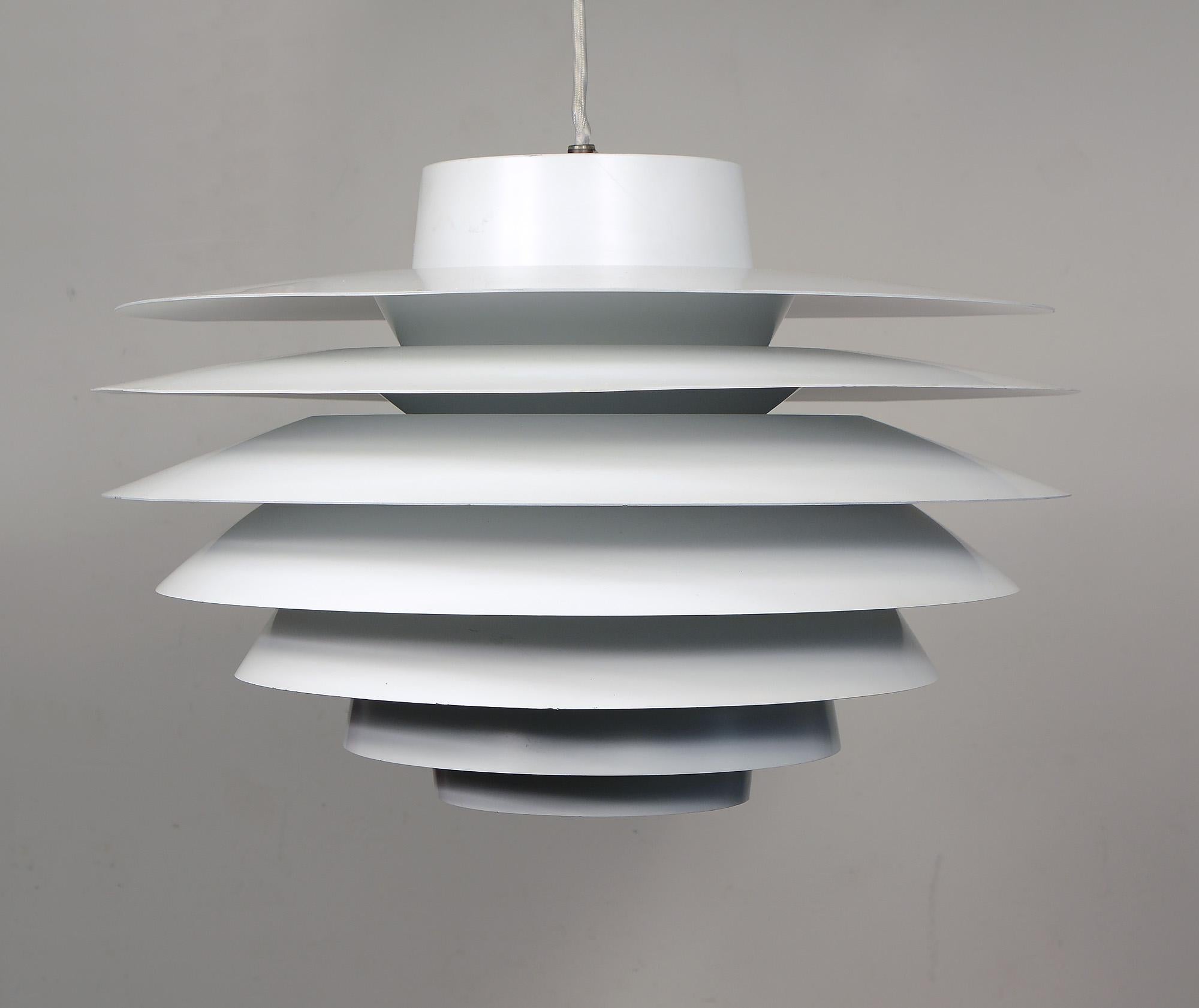 Verona pendant designed by Svend Middelboe in 1968. He was able to design the shades so there are no visible suspensions between the shades - making them almost floating in air. This is the third largest size made. This pendant came out of storage
