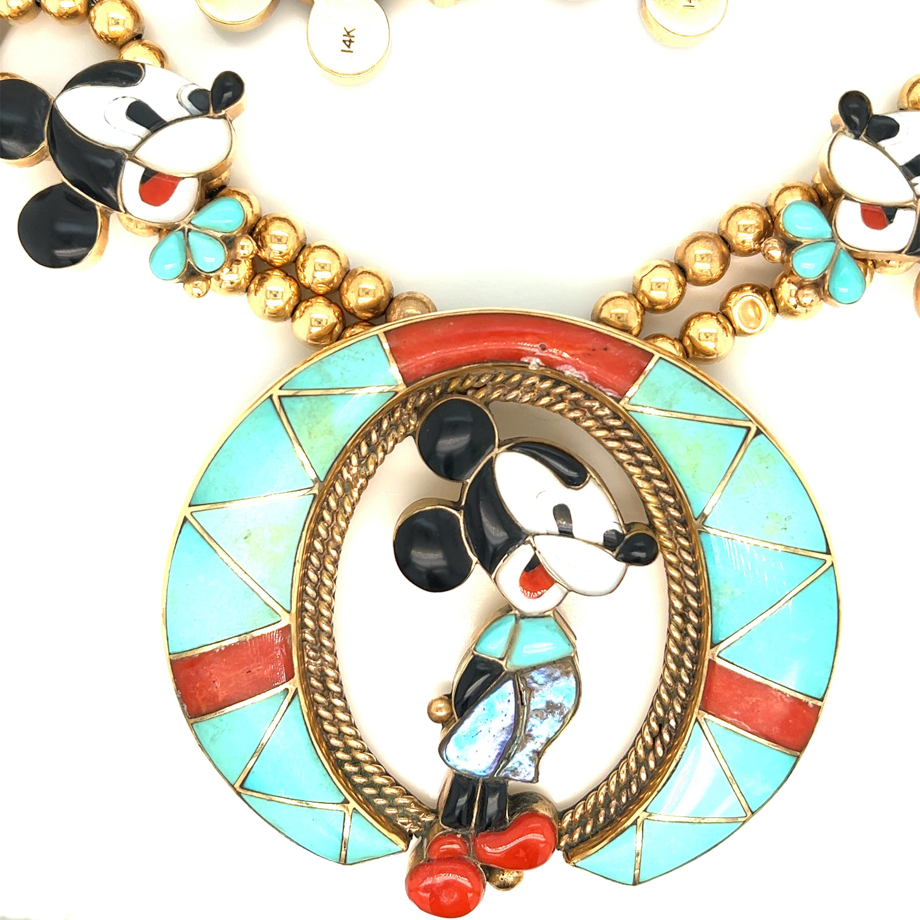 Veronica Poblano Mickey Mouse multi-gem gold double strand necklace, circa 1970s

Black onyx, mother-of-pearl, inlaid turquoise, abalone shell, and coral, 14 karat yellow gold; marked 14kt, with maker's mark 

Size: width 3 inches, length 2.75