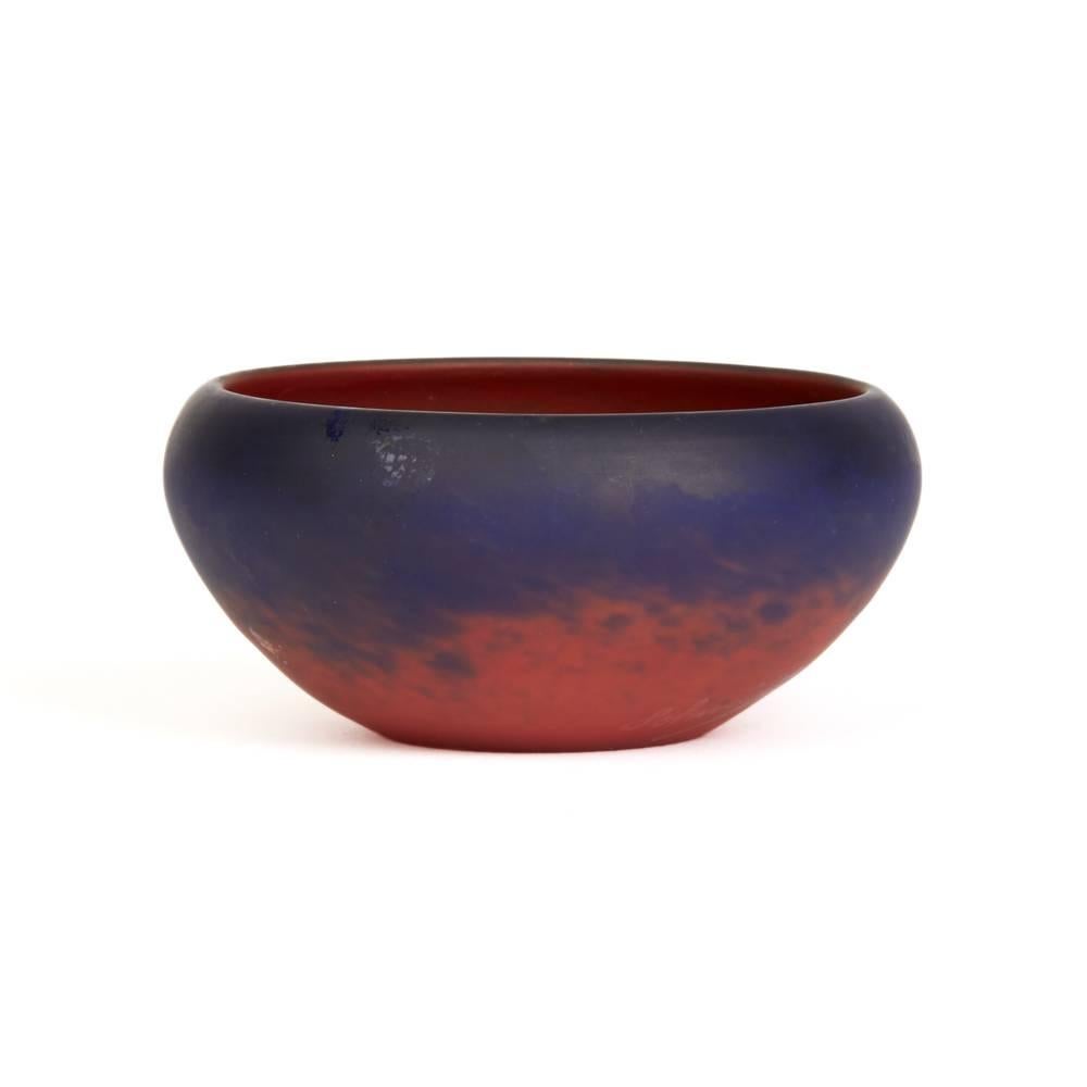 A fine French Art Deco red and blue mottled art glass bowl of wide shallow form with a rounded slightly fold in rim and narrow polished base with red and blue mottled body, the blue intensifying towards the top rim by Schneider Glassworks (Verrerie