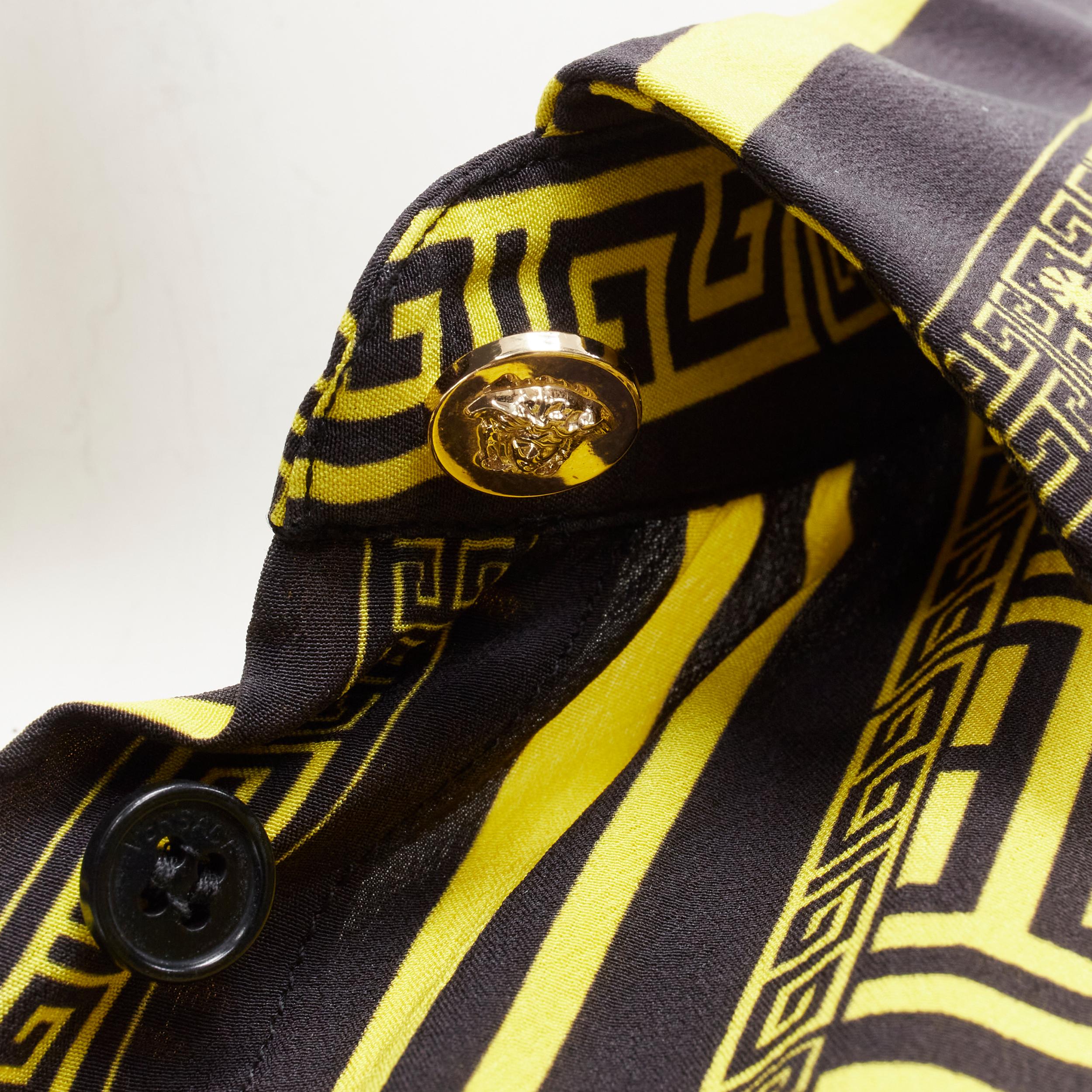 VERSACE 100% silk black gold Greca print Medusa button slim fit shirt IT38 XS 
Reference: TGAS/B01718 
Brand: Versace 
Material: Silk 
Color: Yellow 
Pattern: Geometric 
Closure: Button 
Extra Detail: Gold-tone Medusa button at cuff and collar. Slim