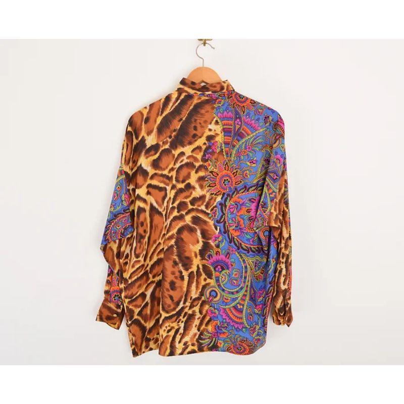 Versace Jeans Couture long sleeved shirt from the early 90's, featuring Leopard and paisley print.

Features
Concealed central line button fasten
Long sleeves
Decorative front & back
Loose fitting
100% Silk
Sizing: Pit to Pit: 25''
Pit to Cuff: