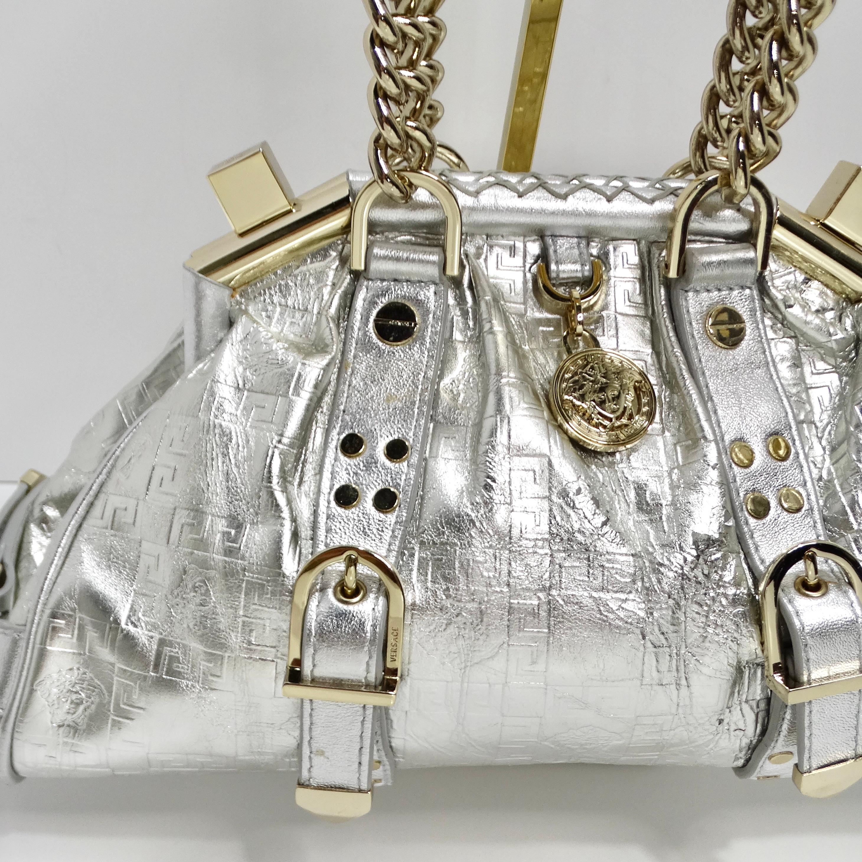 Presenting the Versace 1990s Silver Leather Medusa Shoulder Bag, a dazzling statement piece that captures the bold and luxurious essence of vintage Versace. This iconic handbag is crafted from striking metallic silver leather, creating a captivating