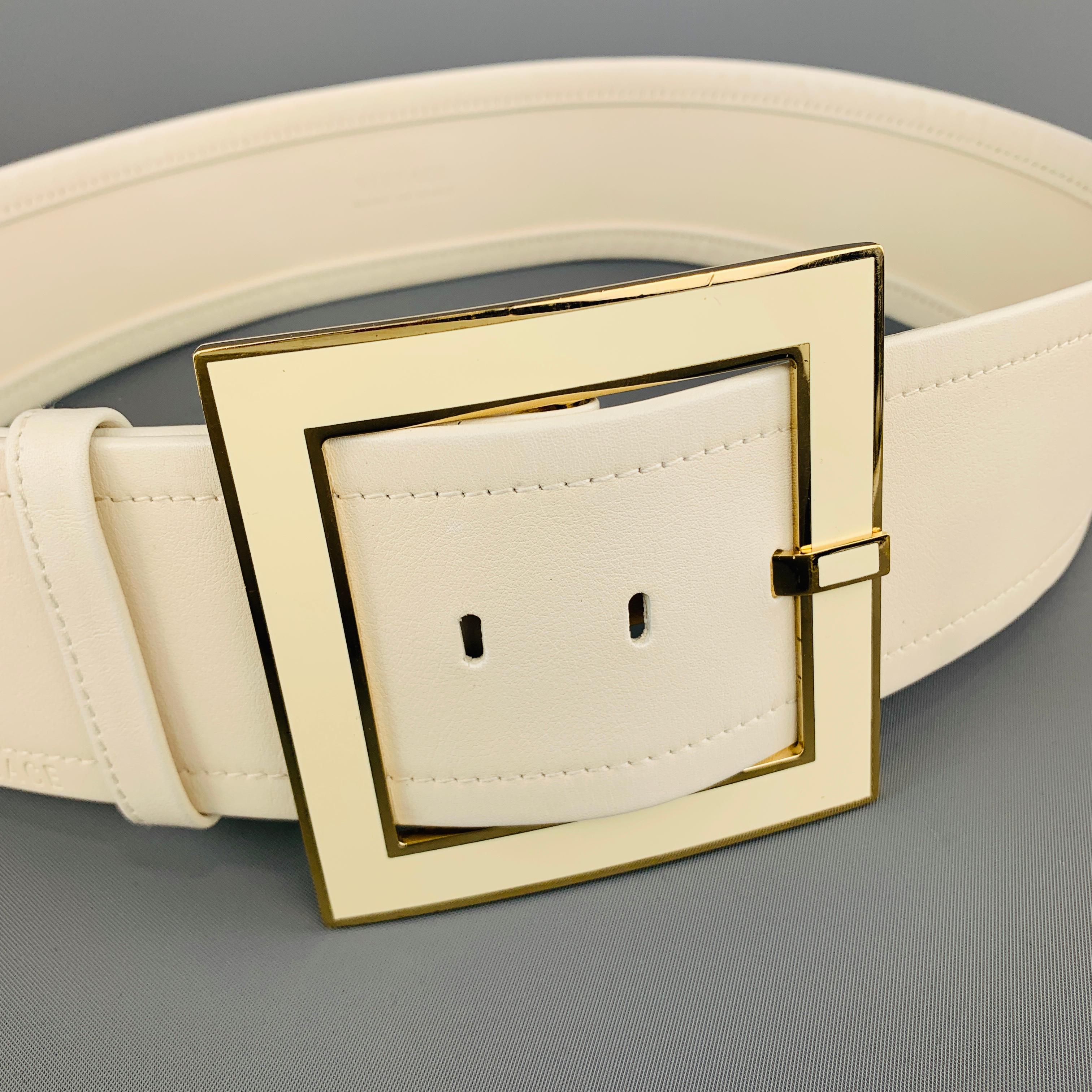 VERSACE waist belt features a thick cream leather strap and oversized gold tone metal and enamel square buckle. Made in Italy.
 
Very Good Pre-Owned Condition.
Marked: 85/34
 
Length: 40 in.
Width: 2.5 in.
Fits: 33-35.5 in.
Buckle: 3.75 x 3.75 in.