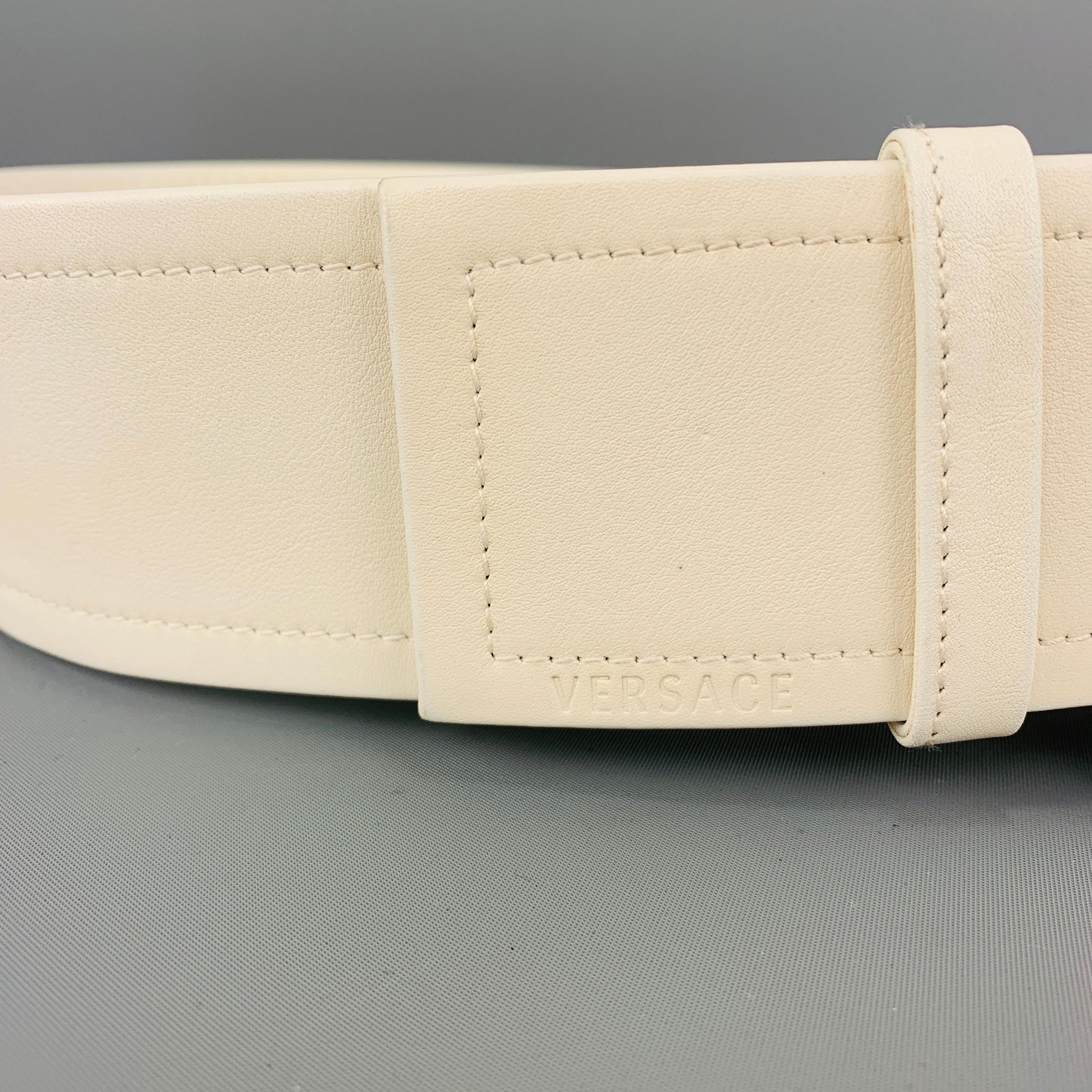 cream belt with gold buckle