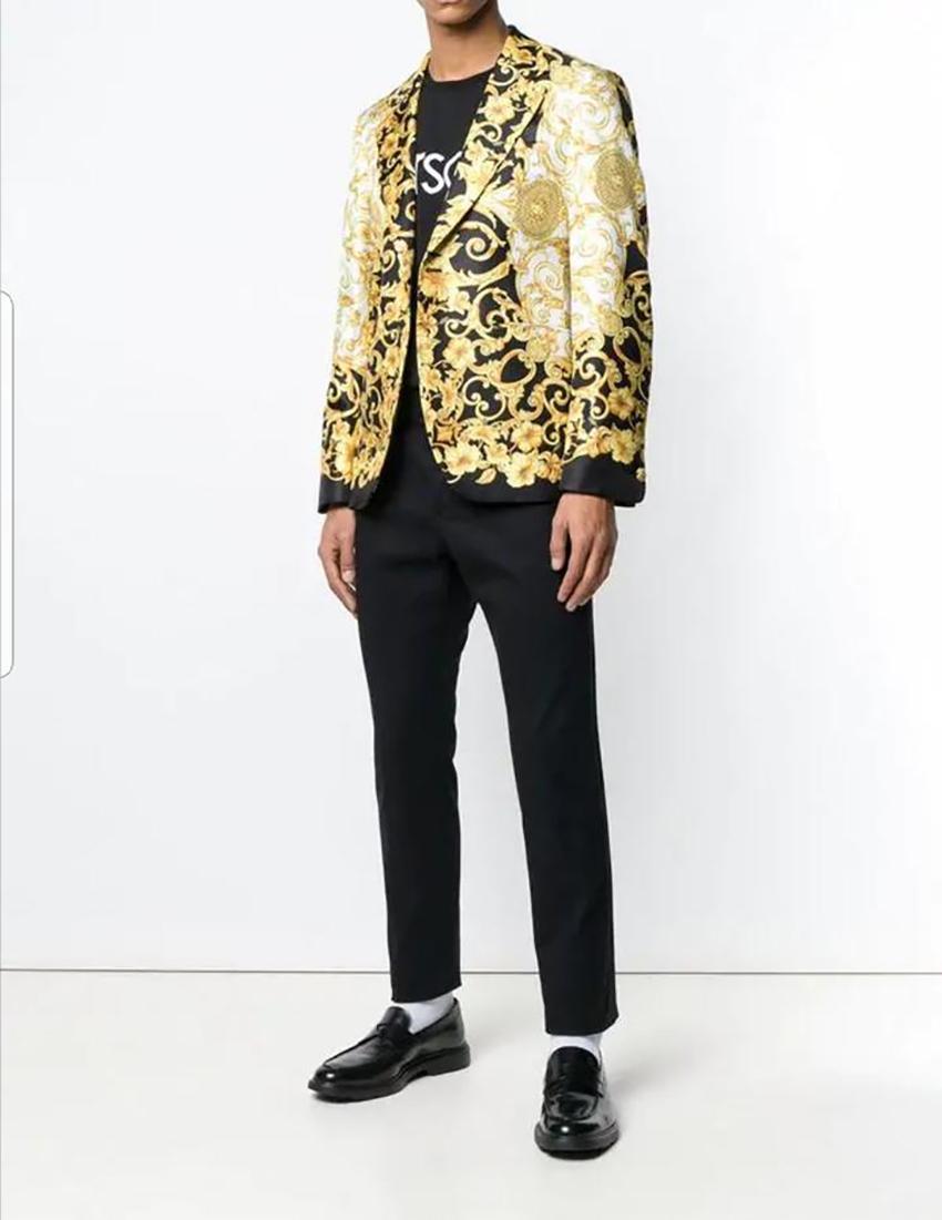 VERSACE  

Baroque print blazer
Since 1978, Versace has been synonymous with luxury fashion. 

For their new collection, the house's iconic prints and bold graphics sit alongside sleek, modern styling. 

This white, gold-tone and black Baroque print