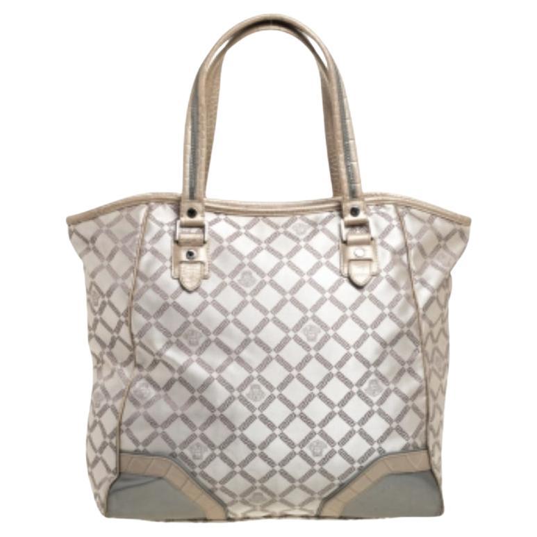 This fabulous tote by Versace is a bag ready to blend in with the busy lifestyle of the women of today. Meticulously crafted from monogram fabric and croc-embossed leather, it features a classy beige hue and dual top handles for you to parade it.