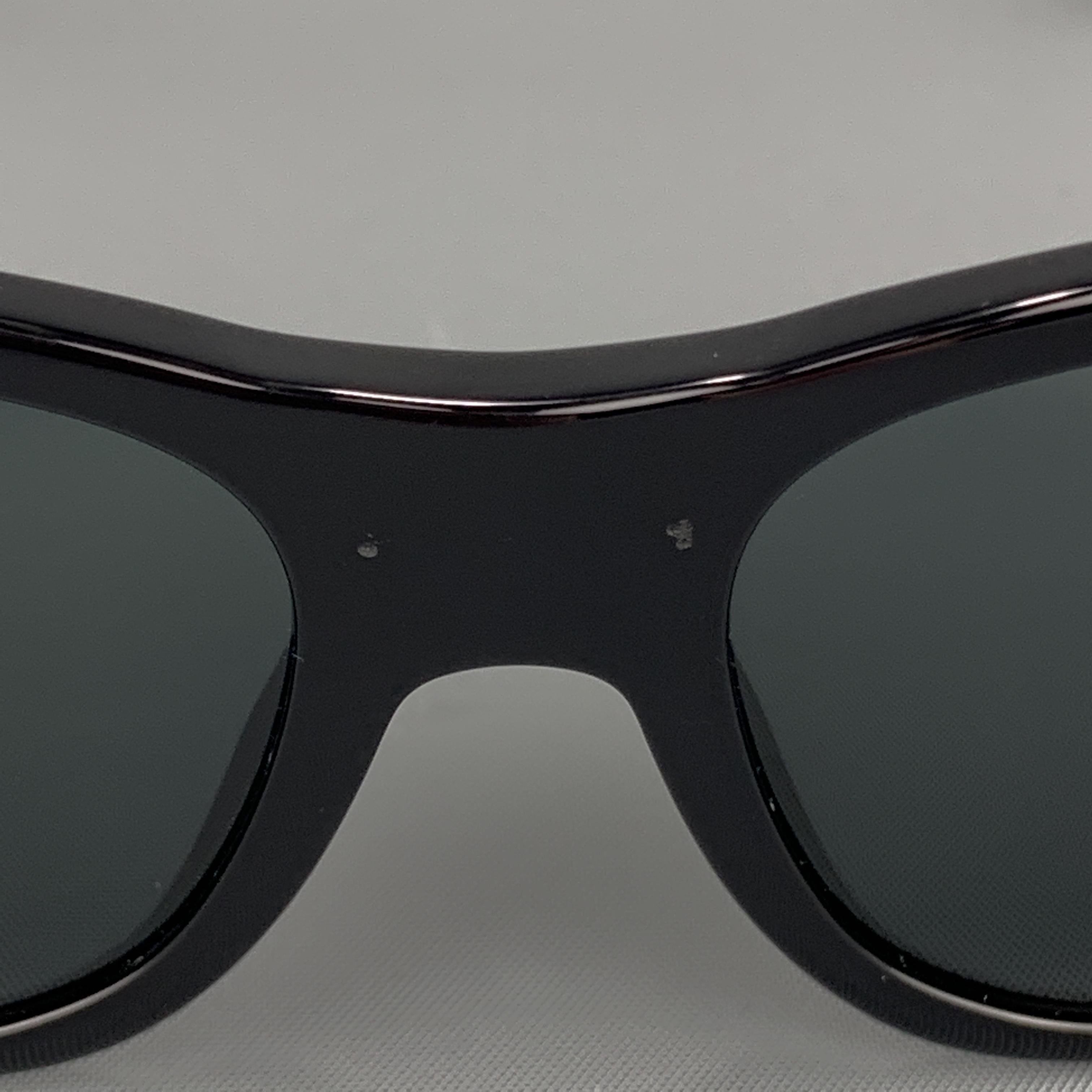 VERSACE sunglasses come in black acetate with thick arms and gold tone Medusa embellishments. Scuffs on center front. As-is. With case. Made in Italy.
 
Very Good Pre-Owned Condition.
Marked: Mod. 4275
 
Measurements:
 
Length: 15 cm.
Height: 5 cm.