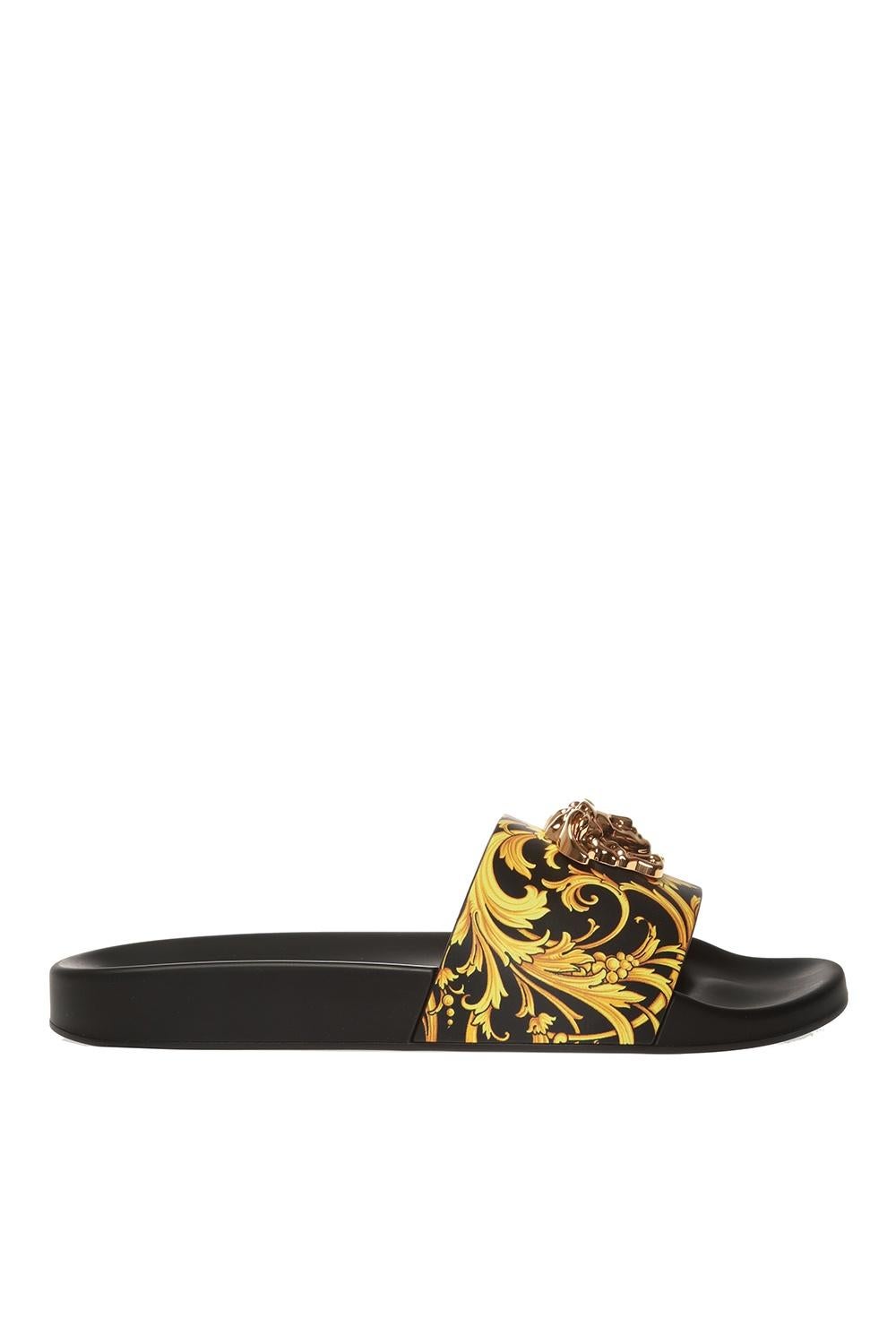Versace Black and Gold Barocco Medusa Embellished Slides

These Versace Barocco Medusa slides will embellish your feet with the true baroque essence. In black leather and rubber, it has an intricate Barocco print on the strap, which is embellished