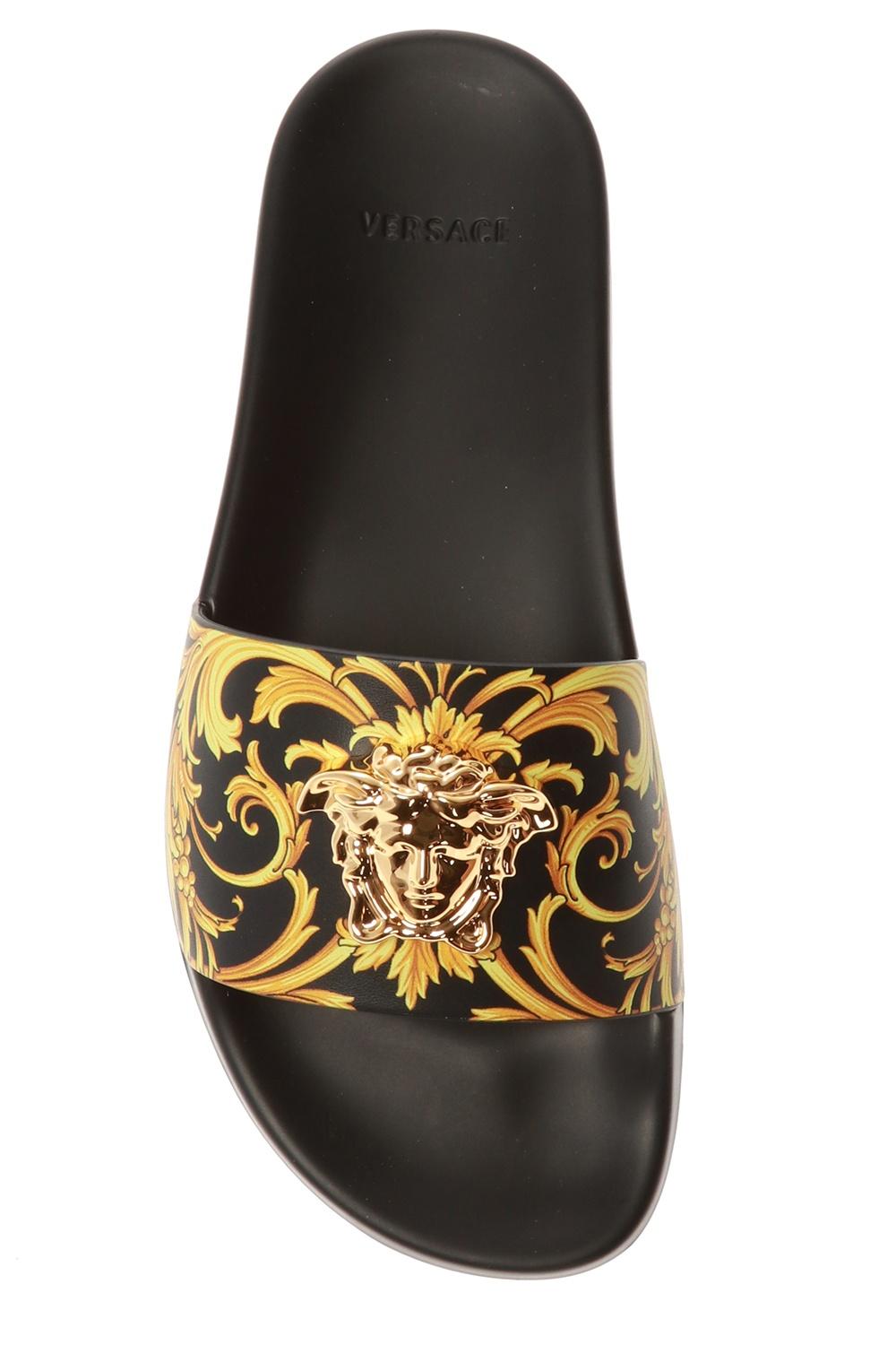 black versace slides with gold medusa