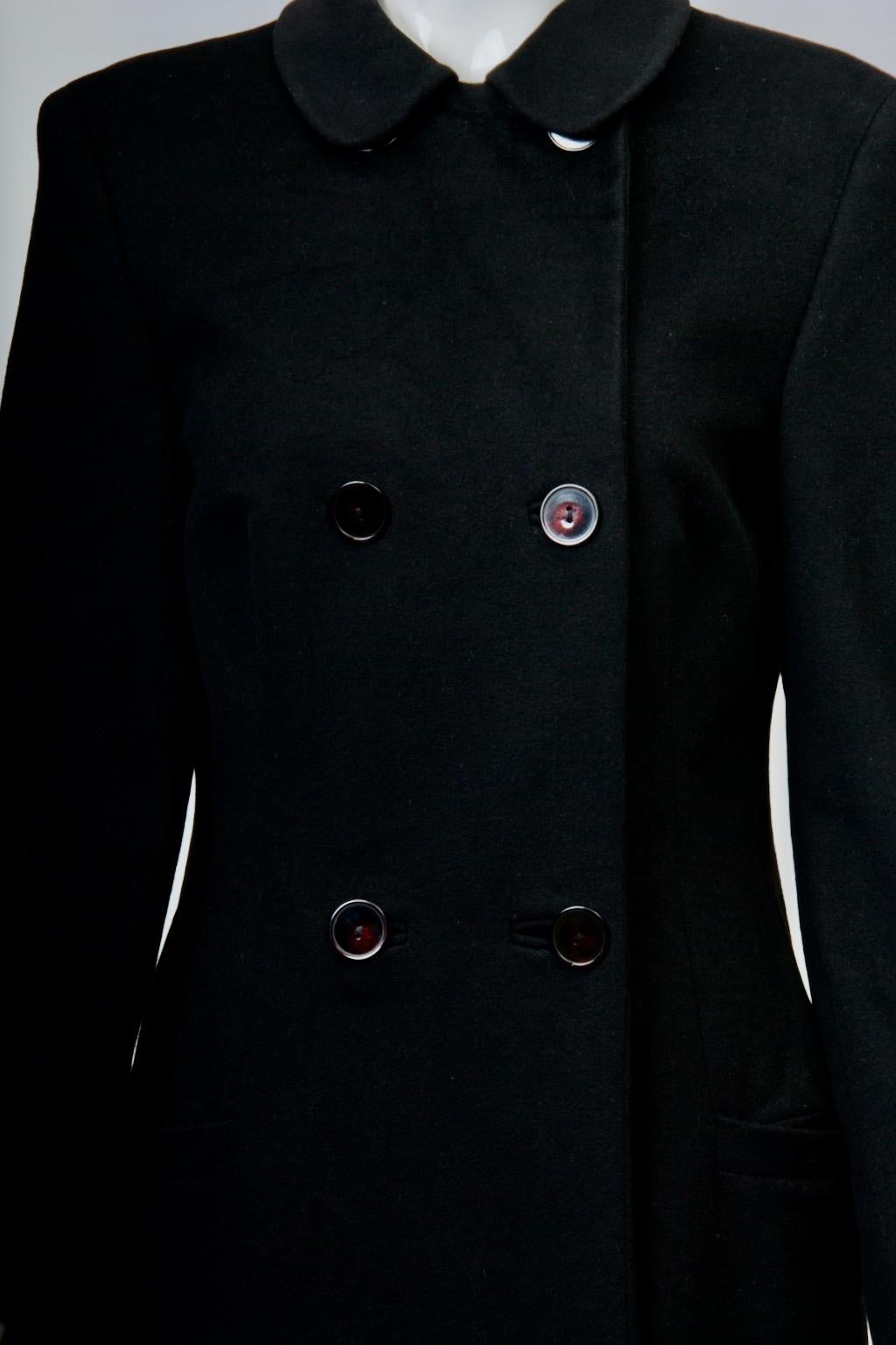c.1990s Gianni Versace coat in soft 15% cashmere/wool blend, featuring a true double-breasted style that buttons up to a small round collar. The body of the coat has seams towards the front and back sides as well as darts in front that shape it to