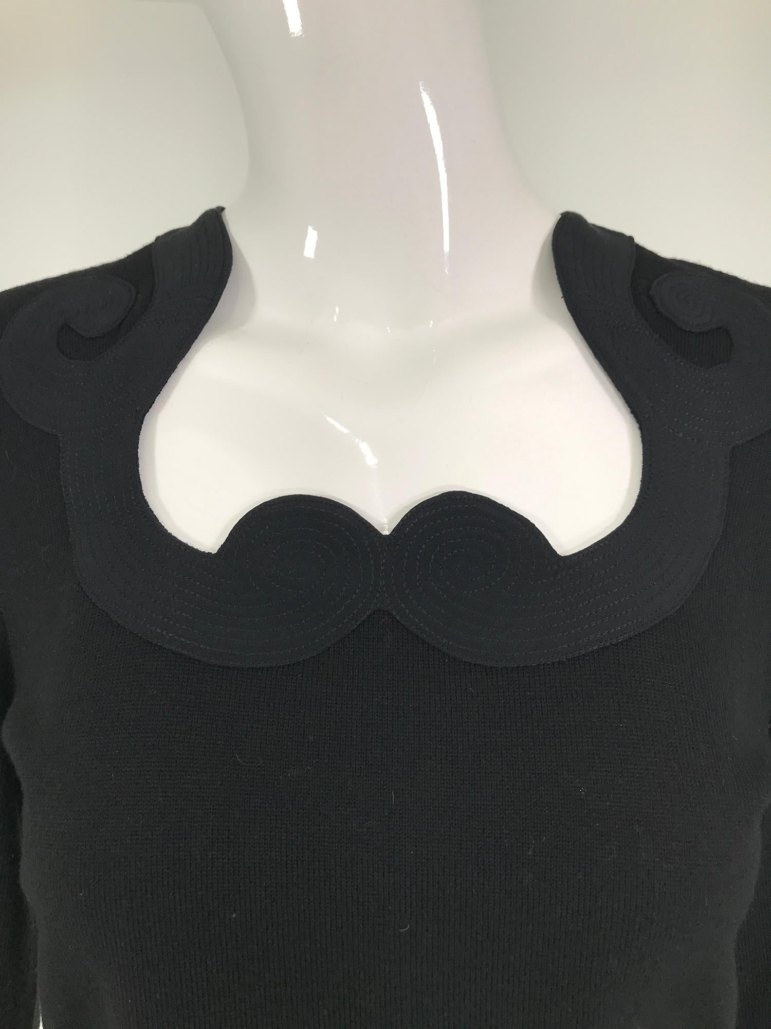 Versace black, fine wool knit pull on sweater with top stitched shaped neck band of silk. Unlined the sweater is soft wool. Marked size medium, fits like a small.
 In excellent wearable condition.  All our clothing is dry cleaned and inspected for