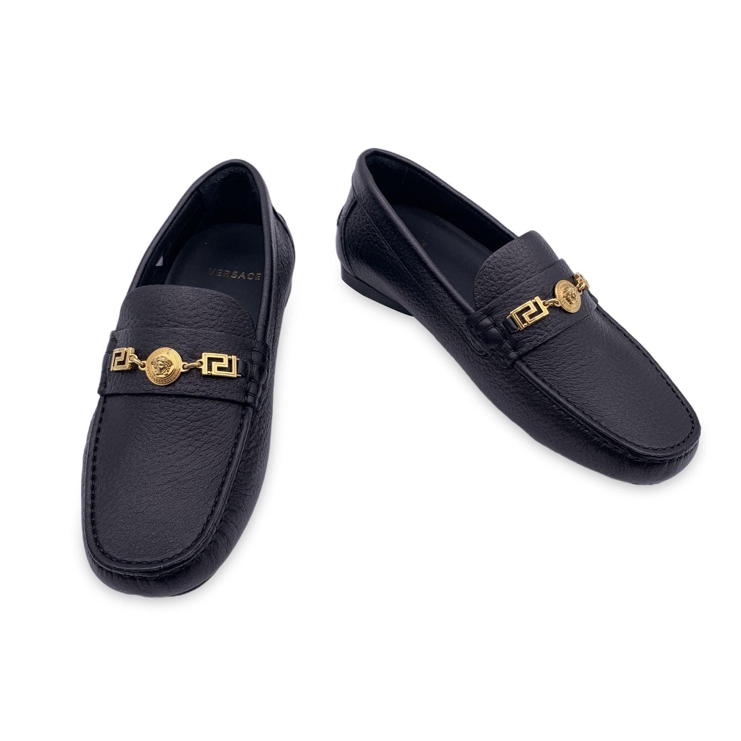 Beautiful Versace black leather Loafers car shoes. Crafted in black leather with gold-tone Medusa and greek detailing. They feature a rounded toe and slip-on design. Rubber sole. Made in Italy. Size: EU 38 (The size shown for this item is the size