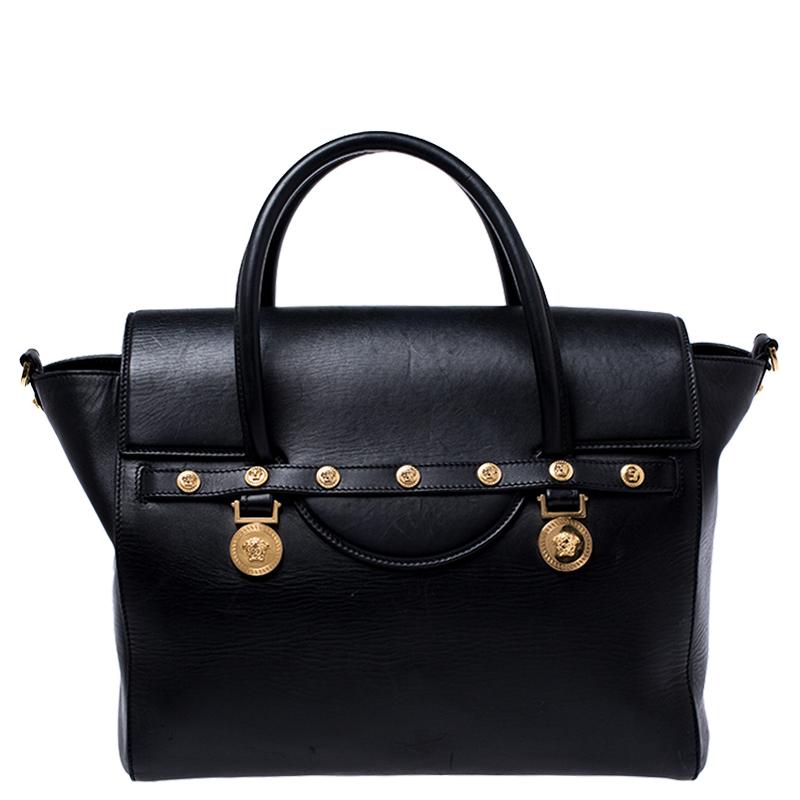 Sophisticated and luxe, this bag from Versace definitely needs to be on your wishlist. The bag is crafted from leather in a lovely black shade and it features a structured silhouette. It flaunts dual handles, a removable shoulder strap and the